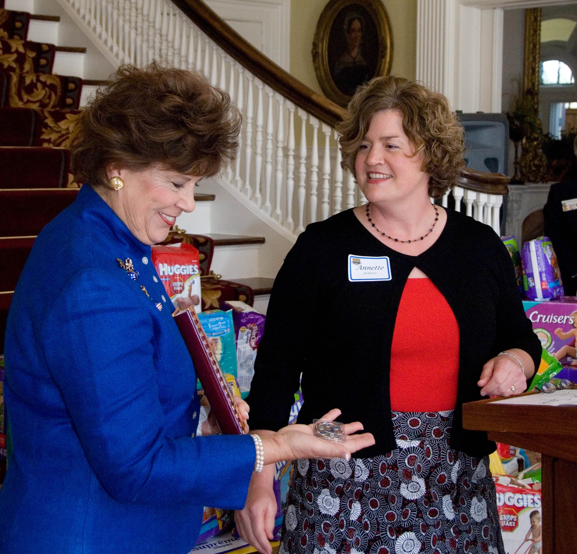 Alabama’s First Lady Patsy Riley receives an Air Command and Staff College cookbook and coin from Annette Roberts, representing ACSC spouses. Several of ACSC spouses were at the Governor’s Mansion Feb. 12 to present the results of the school’s “Diaper Drive” for the Montgomery Family Sunshine Center, one of Mrs. Riley’s charitable interests which supports victims of domestic violence in the Montgomery area. (Air Force photo by Jamie Pitcher)