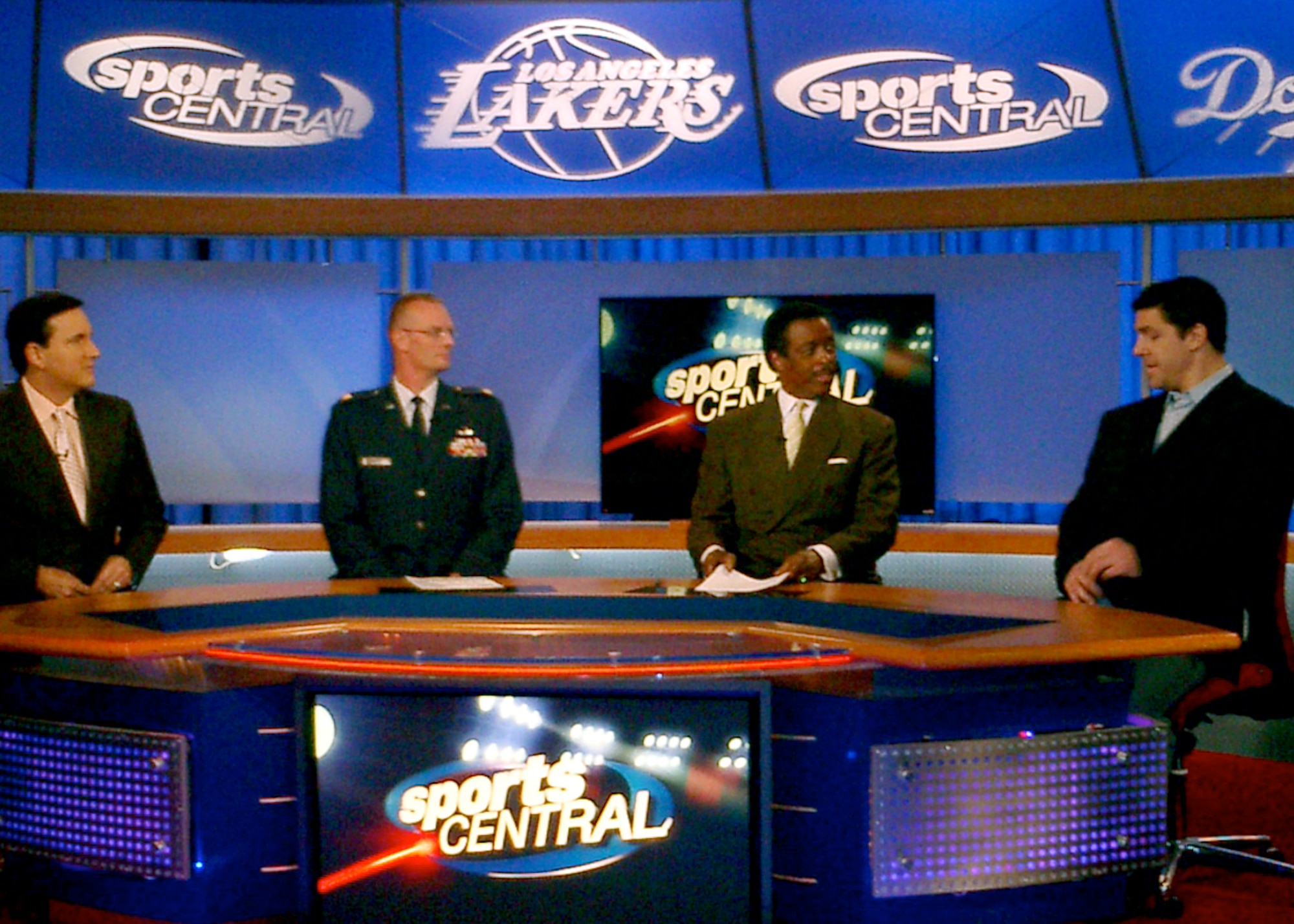 CBS Los Angeles sports anchors Gary Miller (left) and Jim Hill (3rd from left) interview Maj. Dale Winger (2nd from left), Space and Missile Systems Center's Global Positioning Systems Wing, and LA Kings hockey player, Sean O'Donnell (right) during the Channel 2, Sports Central newscast, Feb. 15. Major Winger was honored in Nov. 2008 by the Kings team at The Staples Center as an Air Force military member who had been deployed. Major Winger said the experience was "Awesome. To know that all those fans were cheering to support the military really made us feel appreciated." LA Kings recognize a member of the military on the ice during the National Anthem before each game at The Staples Center.(Photo by Tina Greer)