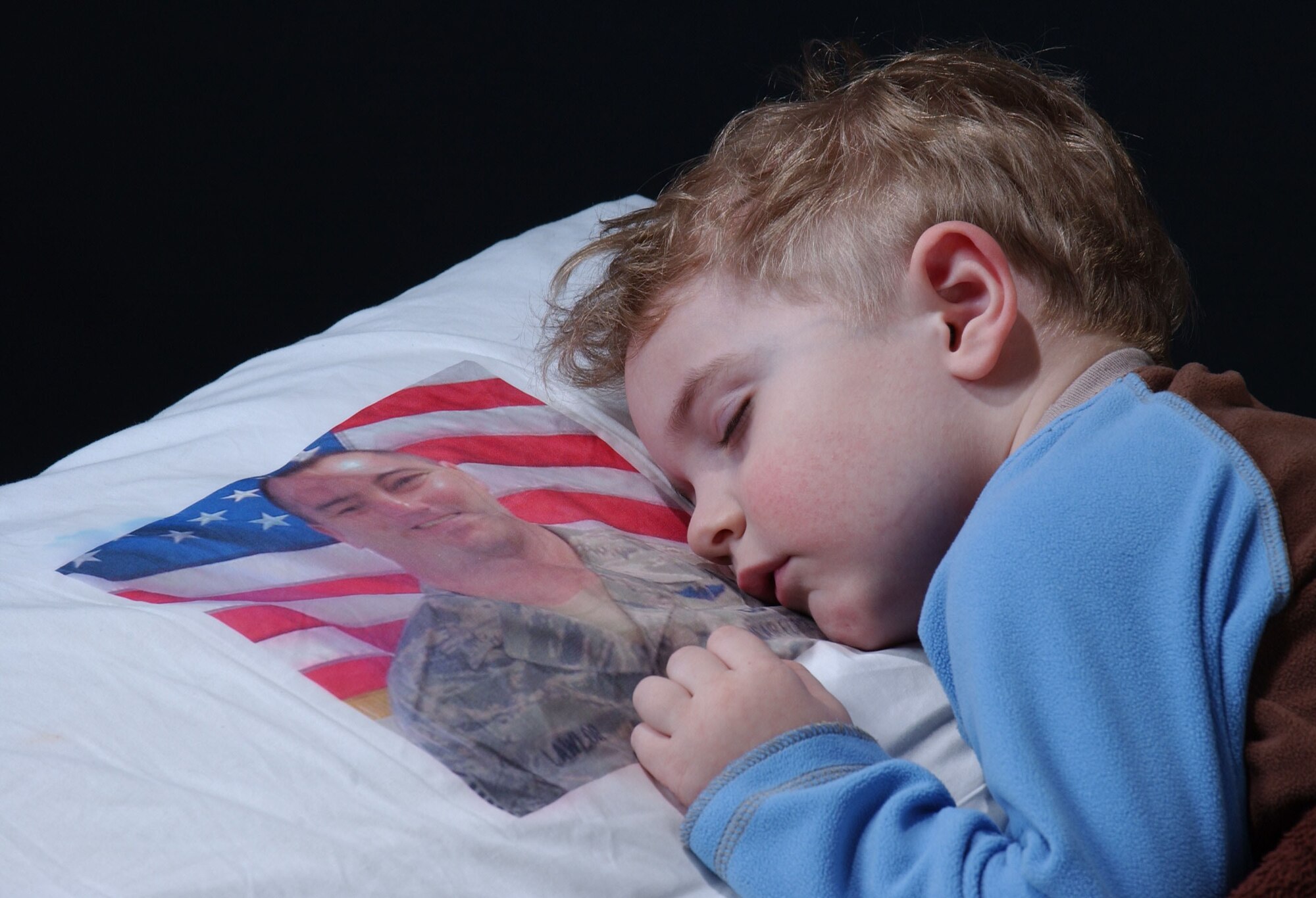 Blain Lawlor, 3, sleeps with his pillow of his father, Master Sgt. Dan Lawlor, 42nd Aerial Port Squadron. OPERATION Pillowcase is one of many initiatives of the Air men and Family Readiness Center that helped earn the staff the 2008 Department of Defense Reserve Family Readiness Award. (US Air Force photo/Staff Sgt. Hueming Mui)                            