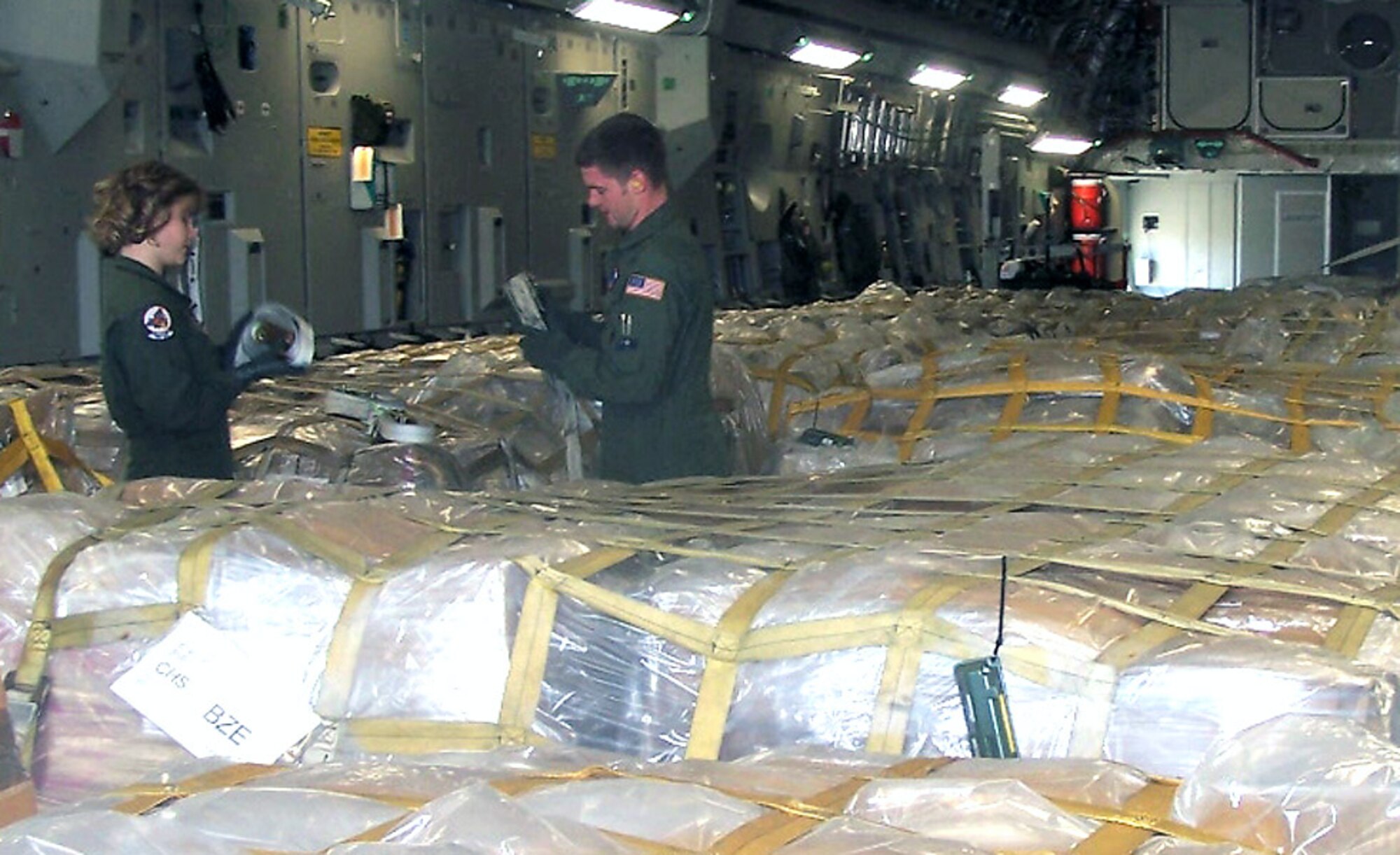 Loadmasters with the Air Force Reserve Command's 701st Airlift Squadron at Charleston Air Force Base, S.C., prepare to unload humanitarian cargo destined for children in Belize. The Denton Amendment allows the U.S. military to transport, on a space-available basis, humanitarian supplies from non-governmental organizations to people around the world who are in need. (U.S. Air Force photo/Maj. Derek Bishop)