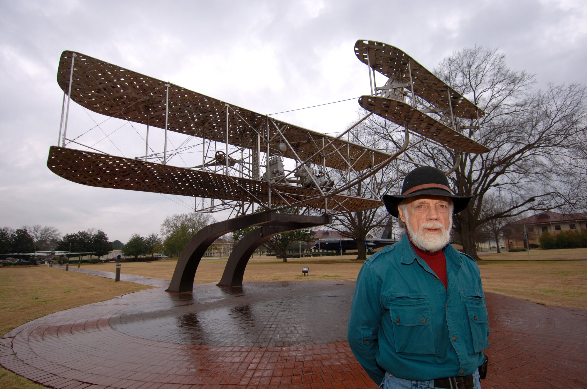 Larry Godwin, of Brundidge, Ala., stands before the Wright Flyer monument he designed and built 24 years ago for Maxwell’s Air Park. Mr. Godwin recently revisited his work while in Montgomery on business. (Air Force photo by Donna Burnett)