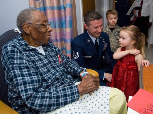 Richard Lockhart, a patient at Montgomery Veteran’s Hospital, receives a valentine Feb. 13 from Katelynn Nelson, age 3.  Also shown are Katelynn’s 5-year-old brother Christopher, and father Tech. Sgt. Jason Nelson. They were all volunteers for the local salute to hospitalized veterans sponsored by the National Department of Veterans’ Affairs. (Air Force photo by Melanie Rodgers Cox)