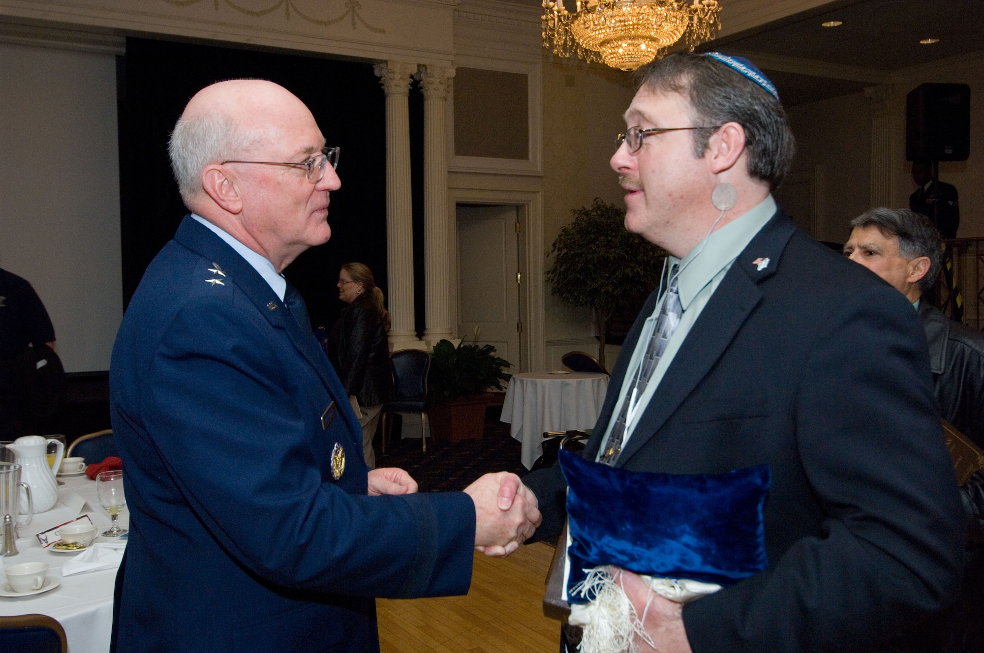 Chap. (Maj. Gen.) Cecil Richardson greets Senior Master Sgt. (ret.) Dave Berry at the Maxwell-Gunter National Prayer Breakfast Feb. 13 at the Maxwell Officers’ Club. Chaplain Richardson, chief of Chaplains for the Air Force, was the keynote speaker.  Sergeant Berry is a local Jewish lay leader. (Air Force photo by Melanie Rodgers Cox)