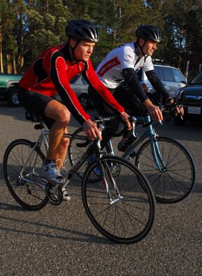 VANDENBERG AIR FORCE BASE, Calif. -- Capt. Noah Rich, 30th Weather Squadron wing weather officer, and Maj. Jonathan Mason, 30th WS assistant director of operations, both members of the Vandenberg Triathlon Club, train on their road bikes after work Feb. 18 here. (U.S. Air Force photo/Airman 1st Class Steve Bauer)