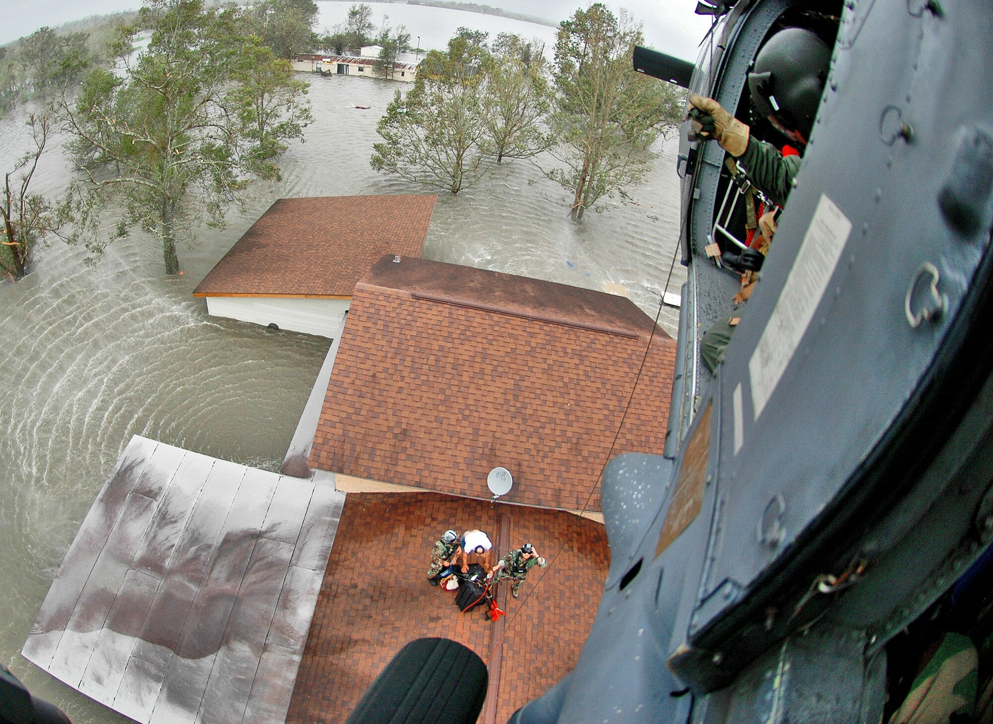 Tech. Sgt. Paul Flipse of the 920th Rescue Wing Public Affairs Office, Patrick Air Force Base, Fla., won the News Photograph category of the 2008 Air Force Reserve Command Media Contest with this photo of wing pararescuemen saving people from floodwaters in Nederland, Texas. In the photo, a homeowner, with his family safely on the helicopter, gathers the last of his belongings before being hoisted up to an HH-60G Pave Hawk. (U.S. Air Force photo)
