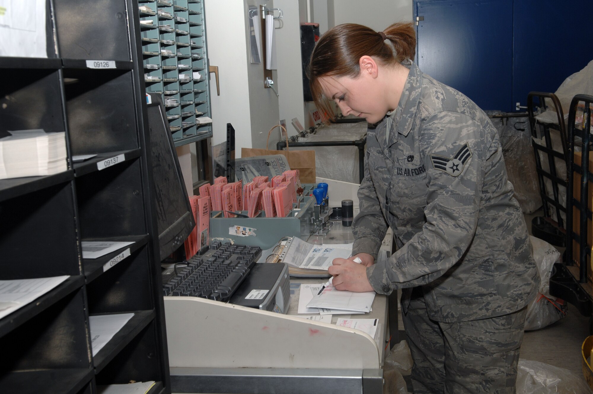 Spangdahlem, Air Base – Senior Airman Anthony Scott, 52nd Communications Squadron postal clerk, marks off errors on outgoing mail Feb. 6, 2009.  The post office hours are from 10 a.m. until 5 p.m. for customer service departments and from 10 a.m. until 5:30 p.m. for the parcel pick-up window.  (U.S. Air Force Photo by Senior Airman Allen Pollard)
