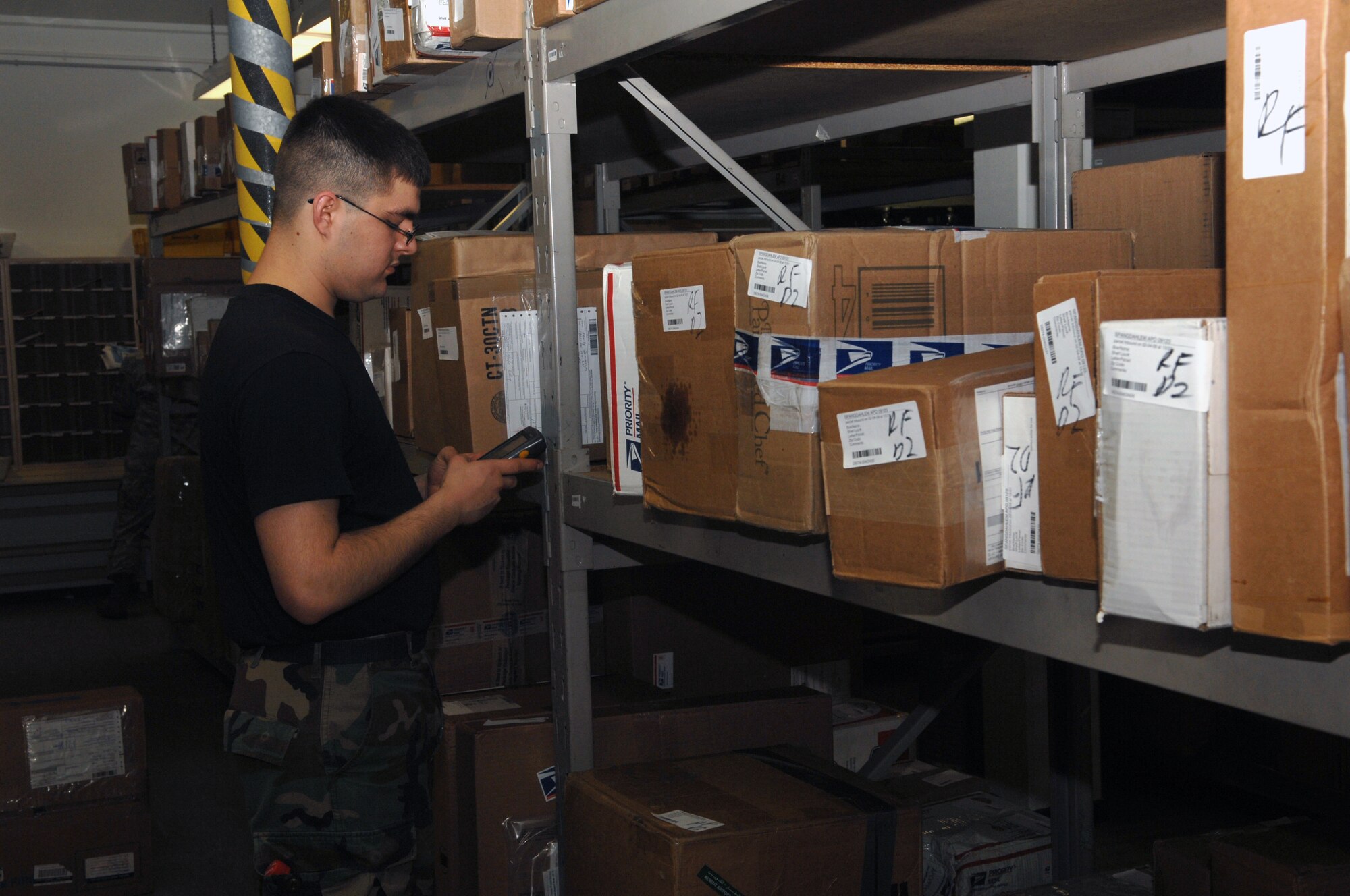 Spangdahlem, Air Base -- Airman 1st Class Evan Delk, 52nd Communications Squadron postal clerk, scans packages into the post office’s tracking system Feb. 6, 2009.  Each package is tracked from when the post office receives it until the person picks the package up from the post office.  (U.S. Air Force Photo by Senior Airman Allen Pollard)