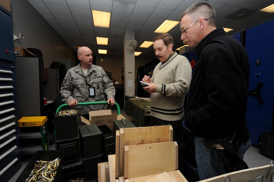Photographer Larry Kesterson and Reporter Ed Colimore, both with the Philadelphia Inquirer, listen as Tech. Sgt. Charles Glunt (left), U.S. Air Force Expeditionary Center armory, provides them with information on the U.S. Air Force Expeditionary Center during a visit on Feb. 17, 2009, to the center on Fort Dix, N.J.  Mr. Kesterson and Mr. Colimore visited to cover the Advanced Contingency Skills Training Course taught by the center's 421st Combat Training Squadron.  The end result is a story and numerous photos in a Sunday edition of The Inquirer.  (U.S. Air Force Photo/Staff Sgt. Nathan Bevier)