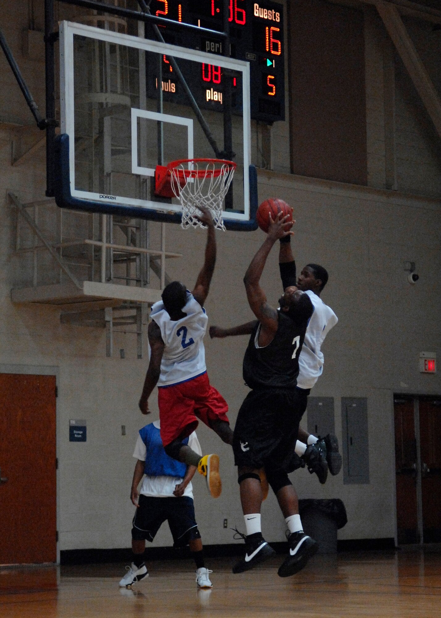 LRS 2 defenders attempt to block Lamar Hancock as he shoots the ball during the intramural basketball game at the Fitness and Sports Center Feb. 18. FSS dominated LRS 2 72-25. Hancock is a member of the 437th Force Support Squadron. (U.S. Air Force photo/Senior Airman Katie Gieratz) 