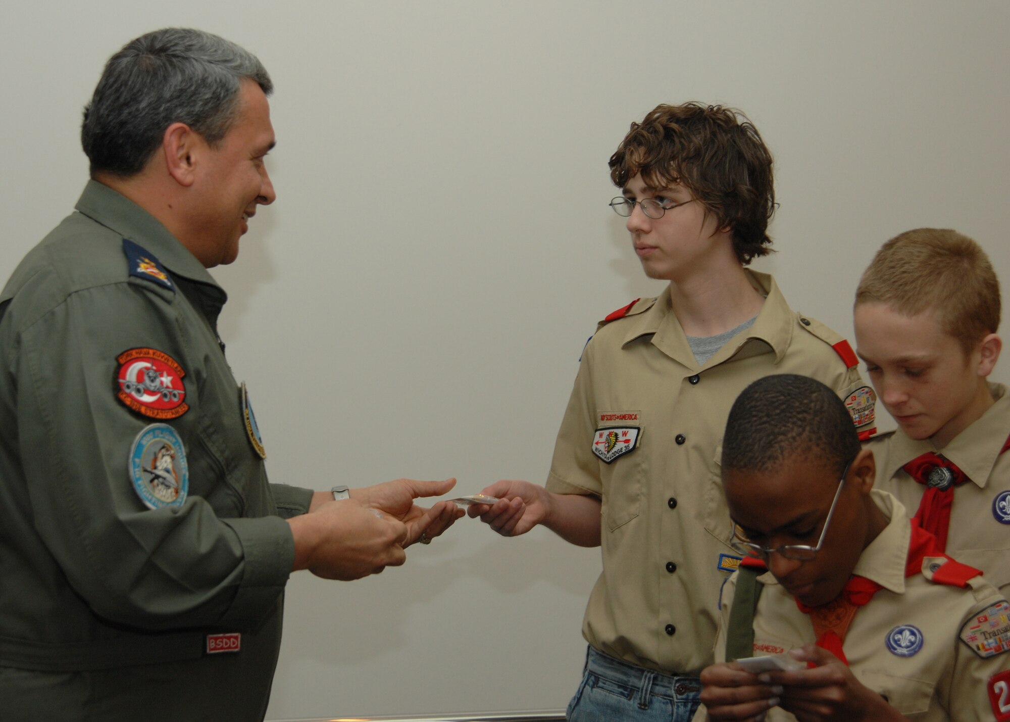 Brig. Gen. Haluk Selvi, 10th Tanker Base commander, presents Eric Price with a pin. Boy Scout Troop 218 visited the Turkish Air Force general to present him with a certificate of recognition to thank him for his support towards the Boy Scout Troop. (U.S. Air Force photo by Senior Airman Lauren Padden 39th Air Base Wing public affairs) 
