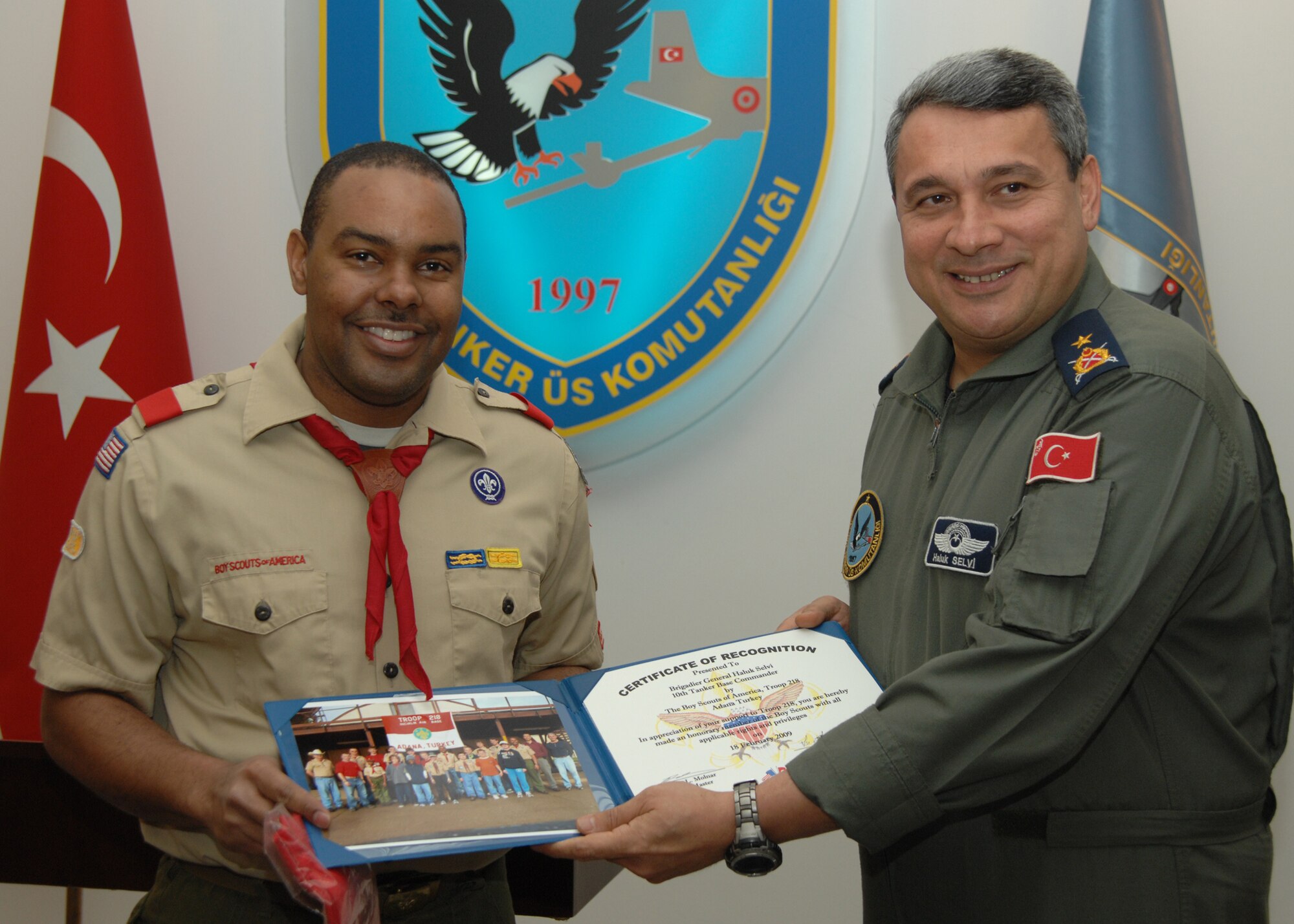 Capt. Lee Sims, Boy Scout Troop 218 leader, presents Brig. Gen. Haluk Selvi, 10th Tanker Base commander, a certificate of recognition at Incirlik Air Base, Turkey, Feb. 18. The certificate declares General Selvi as an honorary member of the Boy Scouts. (U.S. Air Force photo by Senior Airman Lauren Padden 39th Air Base Wing public affairs)