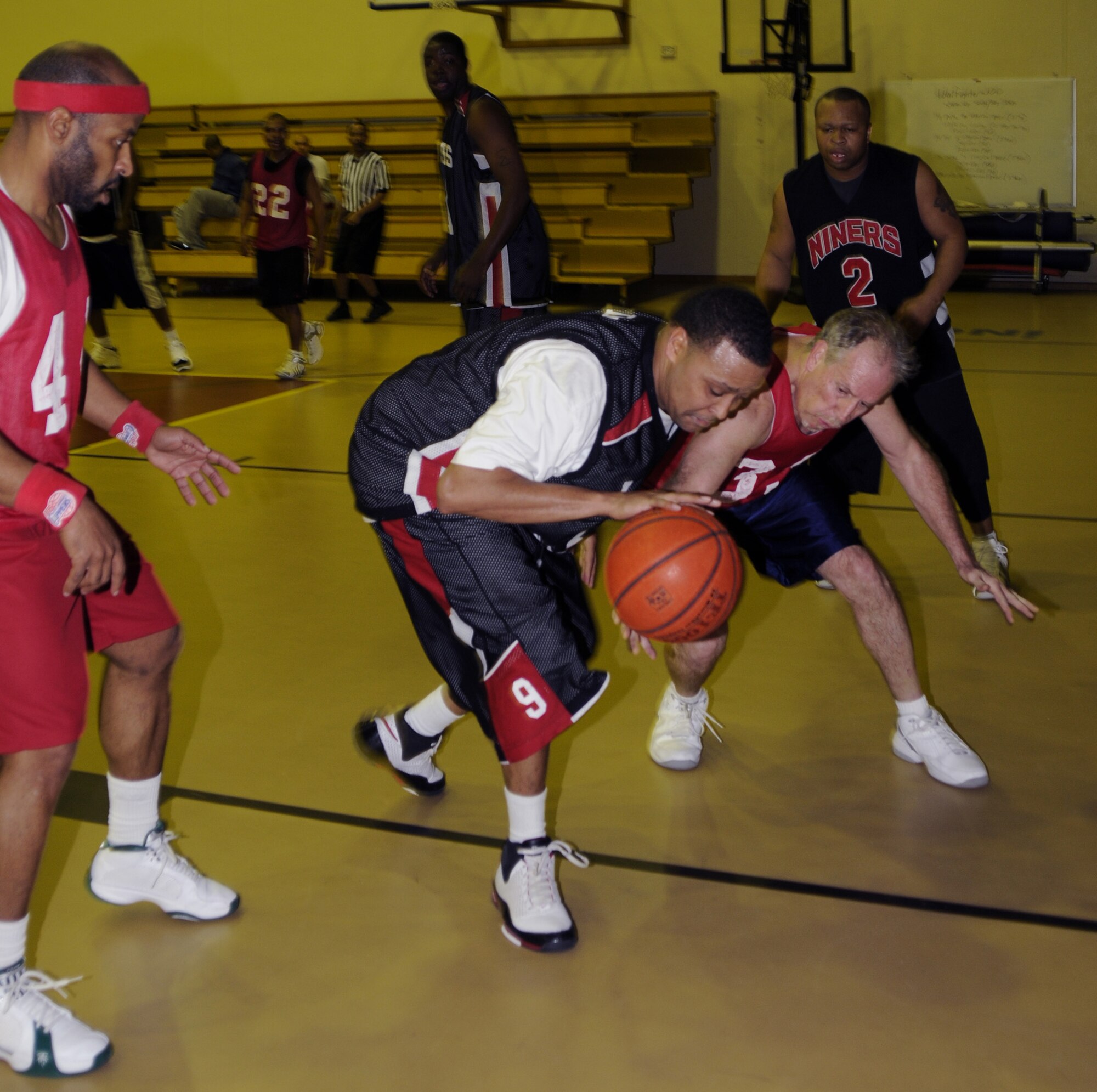 John Drake, Department of Defense Dependents School guard, tries to steal the ball from Lamar Dixon 39th Logistics Readiness Squadron at the Incirlik Fitness Center, Feb. 17 during the over-30 championship game.  DoDDs won, scoring 62 to LRS’ 54 points. (U.S. Air Force photo by Airman 1st Class Amber Russell)