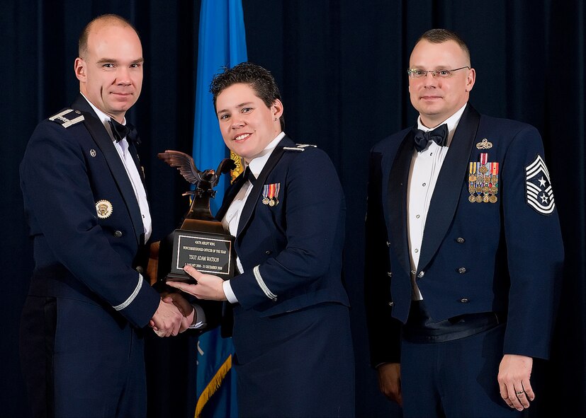 (Left) Col. Manson Morris, 436th Airlift Wing commander, and Chief Master Sgt. John Wood, 436th AW command chief, present Captain Rebecca Corbin, 436th Civil Engineer Squadron, with the award for Non-commissioned Officer of the Year during the Annual Awards ceremony Feb. 13.  Capt. Corbin was accepting on behalf of Tech. Sgt. Adam Watson, 436th CES, who is currently deployed.  (U.S. Air Force photo/Roland Balik)