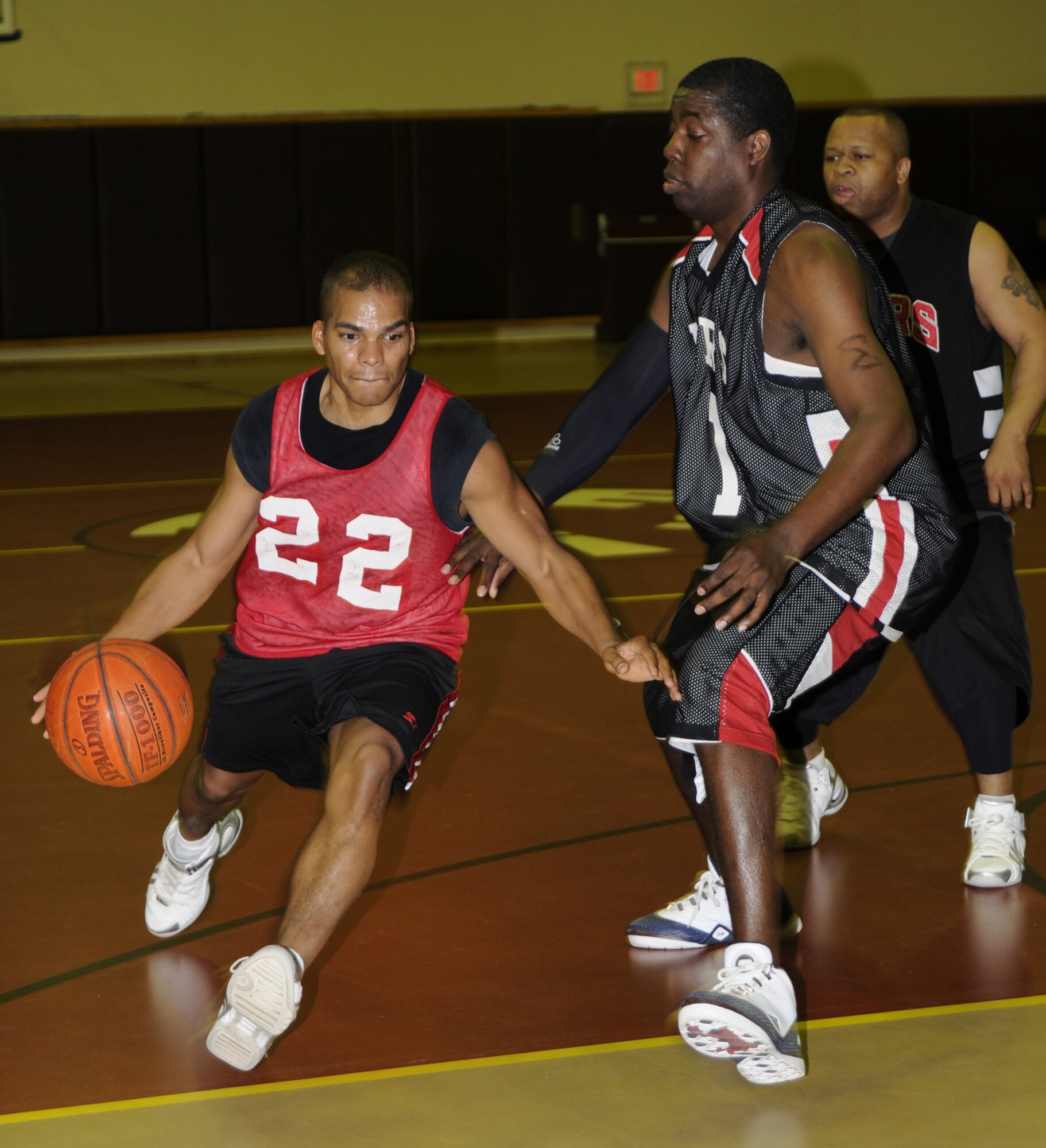 Adanzy Hart, Department of Defense Dependents School guard, dribbles the ball around the defense, during the over-30 championship game Feb. 17 at the Incirlik Fitness Center.  DoDDs won the title 62 - 54.  (U.S. Air Force photo by Airman 1st Class Amber Russell)