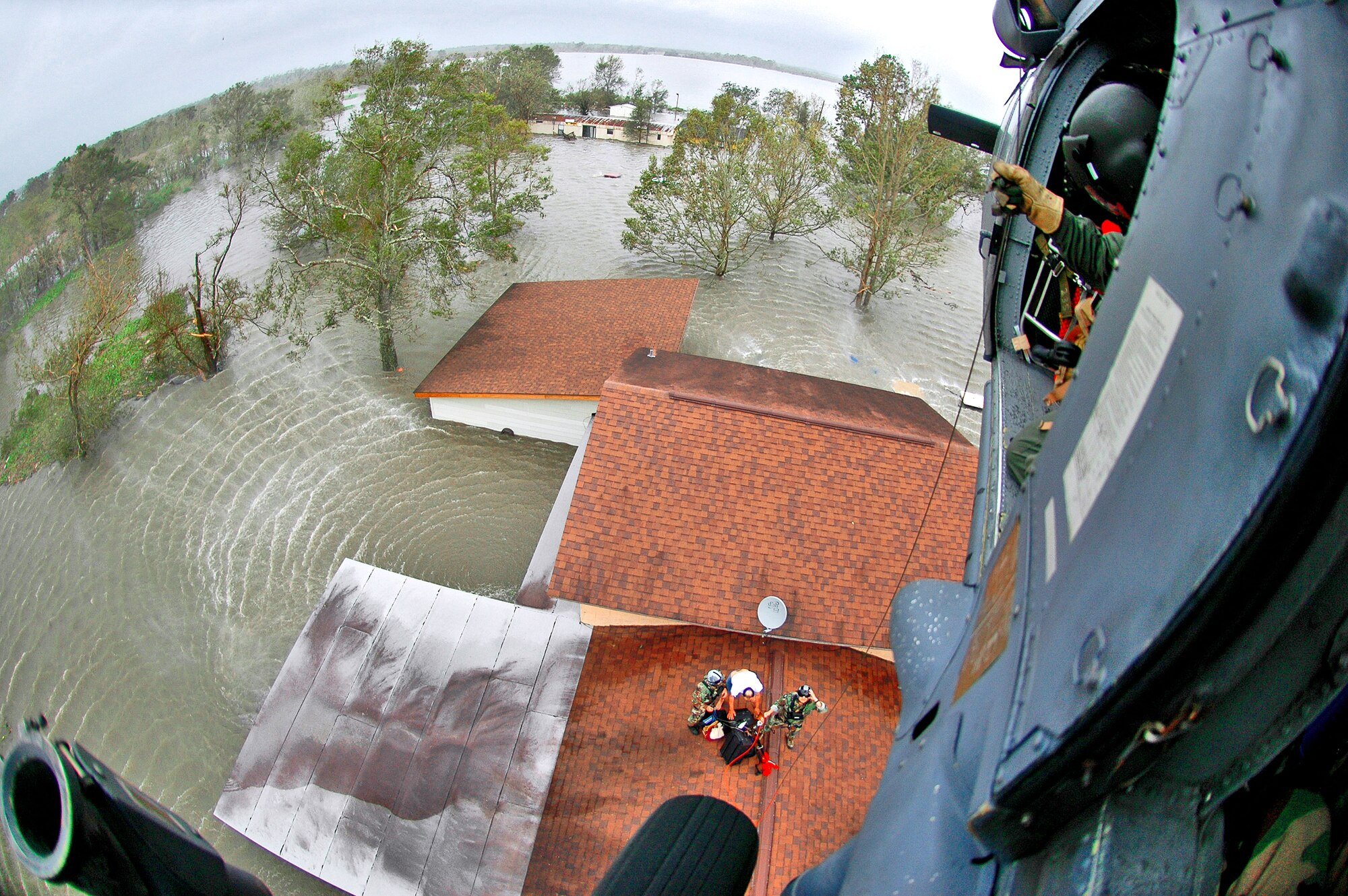 NEDERLAND, Texas -- Pararescuemen from the 920th Rescue Wing saved 17 people from floodwaters in the aftermath of Hurricane Ike. With his family safely on one of the wing's HH-60G Pave Hawk rescue helicopters, a homeowner gathers the last of his belongings before being hoisted up. (U.S. Air Force photo/Tech. Sgt. Paul Flipse)