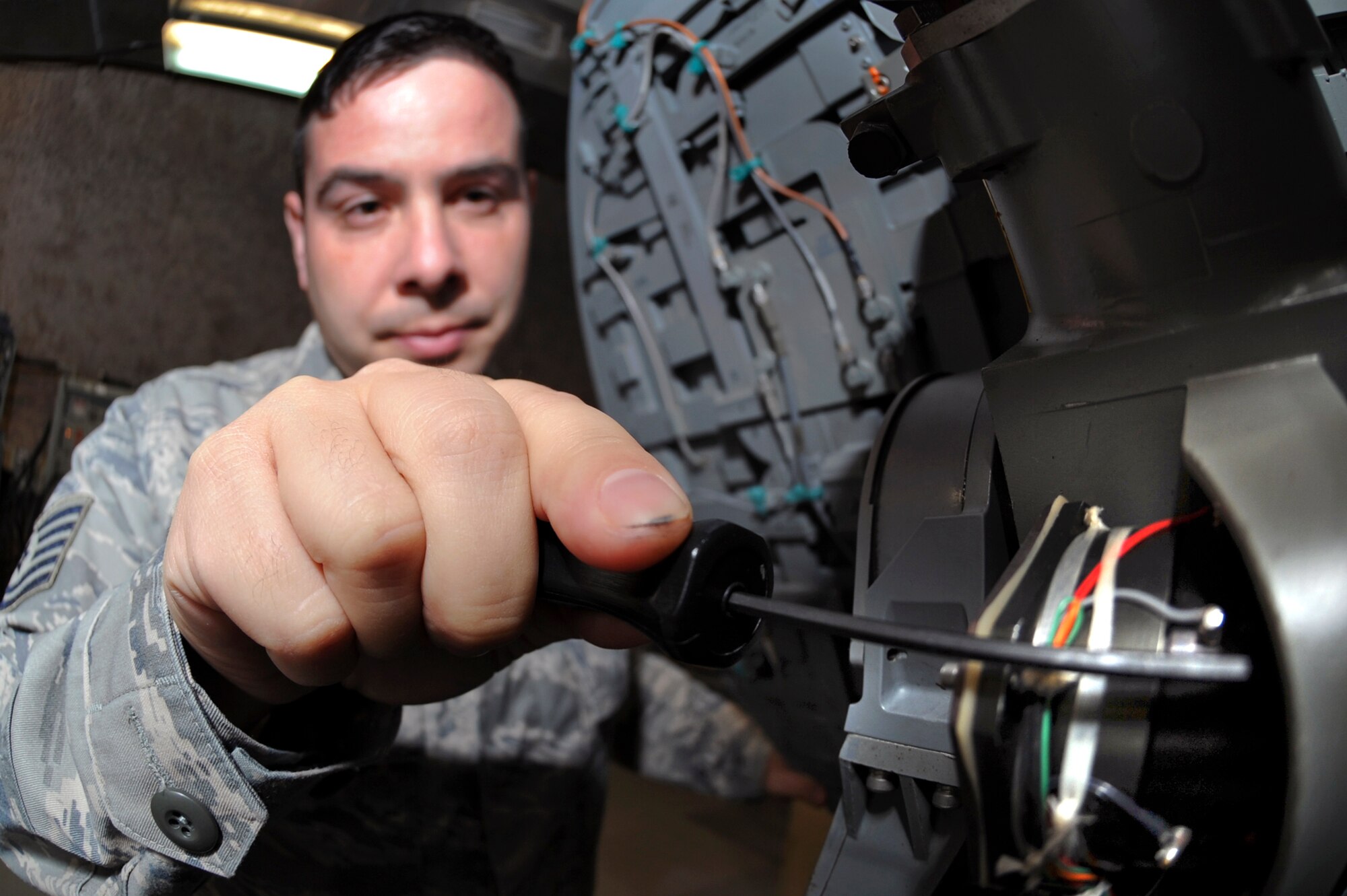 Tech. Sgt. Henry Diogo, the F-15E Avionics Production Supervisor with the 379th Expeditionary Maintenance Squadron, performs a quality assurance inspection on an F-15E Strike Eagle radar antenna, Feb. 19, 2009, in an undisclosed location in Southwest Asia.  The antenna directs the radar energy which allows the pilot of the aircraft to locate and lock onto targets.  Sergeant Diogo is native to White Plains N.Y., and is deployed from Royal Air Force, Lakenheath, England in support of Operations Iraqi and Enduring Freedom and Combined Joint Task Force - Horn of Africa.  (U.S. Air Force Photo by Staff Sgt. Joshua Garcia/released)