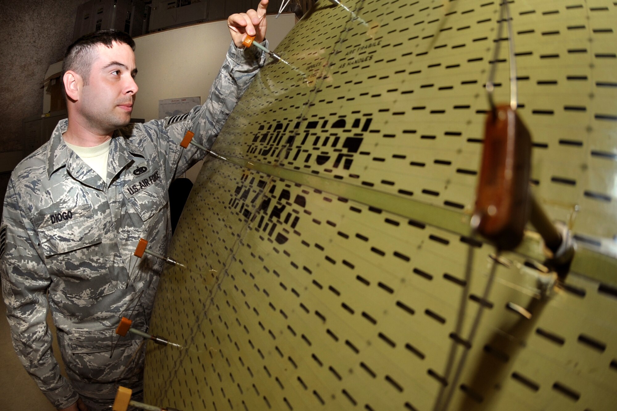 Tech. Sgt. Henry Diogo, the F-15E Avionics Production Supervisor with the 379th Expeditionary Maintenance Squadron, performs a quality assurance inspection on an F-15E Strike Eagle radar antenna, Feb. 19, 2009, in an undisclosed location in Southwest Asia.  The antenna directs the radar energy which allows the pilot of the aircraft to locate and lock onto targets.  Sergeant Diogo is native to White Plains N.Y., and is deployed from Royal Air Force, Lakenheath, England in support of Operations Iraqi and Enduring Freedom and Combined Joint Task Force - Horn of Africa.  (U.S. Air Force Photo by Staff Sgt. Joshua Garcia/released)