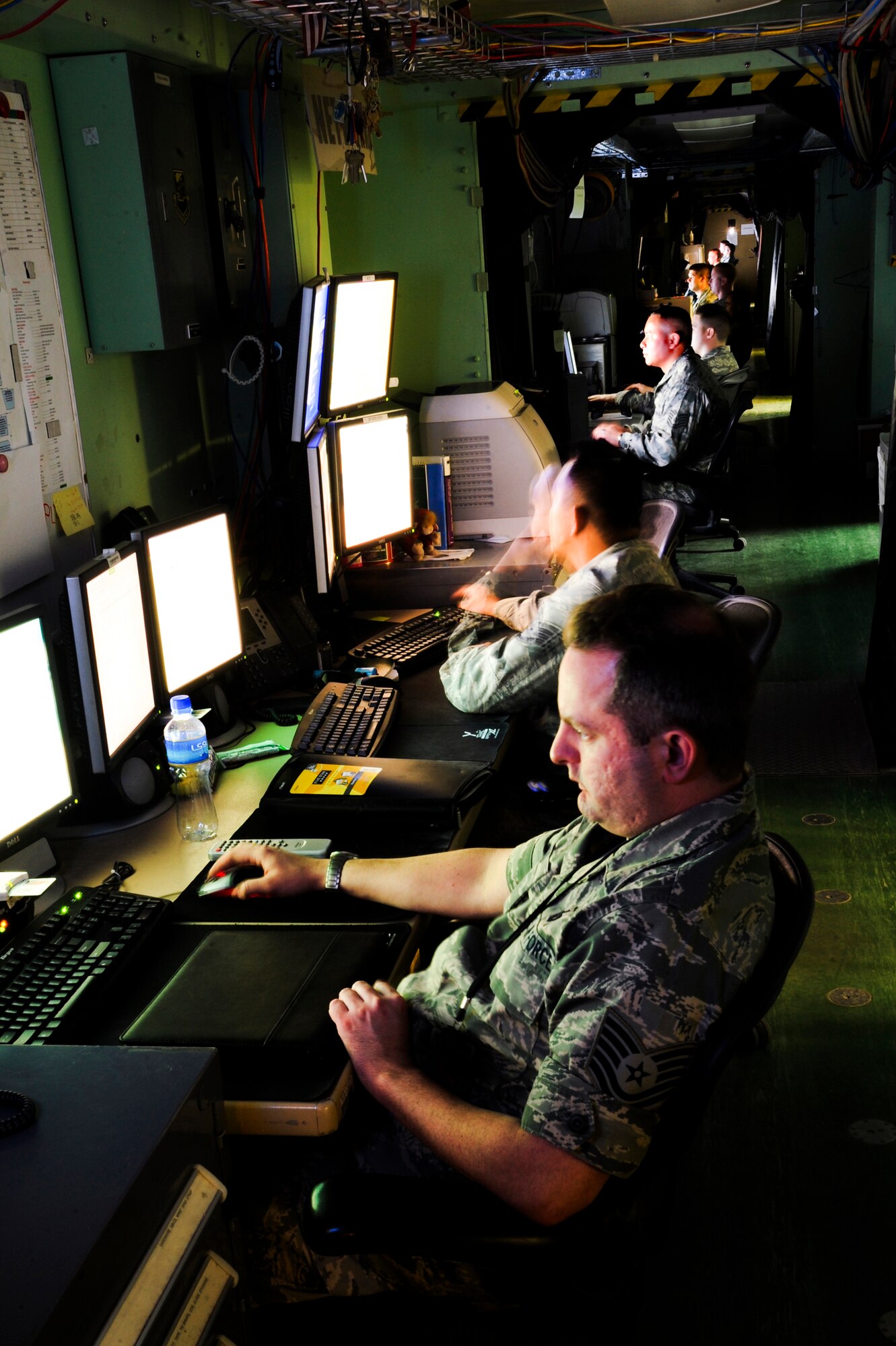 Tech. Sgt. Jason Marks, the Non-Commissioned Officer in Charge of the Combined Air and Space Operations Center (CAOC) Network Infrastructure shop, and Staff Sgt. George Galliguez, a CAOC Network Infrastructure Technician, along with members of the CAOC Communications Support Team, handle the daily missions that each section is in tasked with, Feb. 18, 2009, in an undisclosed location in Southwest Asia.  The CAOC's Communications Support Team provides Command and Control Computer Communications and Information network architecture to facilitate air tasking order production, execution, dissemination, and combat operations assessment.  Sergeant Marks is native to Mount Dora, Fla. and deployed from Kirtland Air Force Base, N.M. and Sergeant Galliguez hails from Los Angeles, Calif. and is deployed from Davis Monthan AFB, Ariz. The CAOC Communications Support Team is deployed in support of Operations Iraqi and Enduring Freedom and Combined Task Force - Horn of Africa.  (U.S. Air Force Photo by Staff Sgt. Joshua Garcia/released)