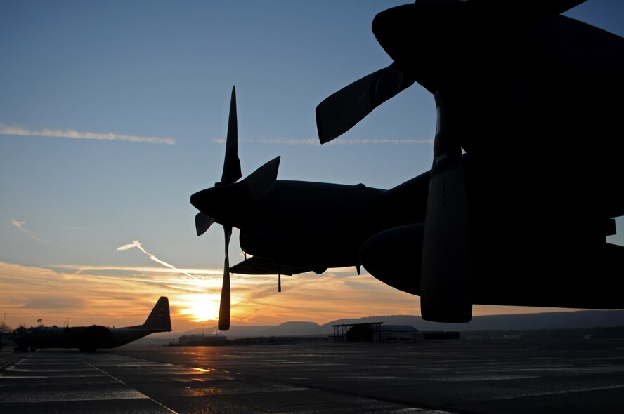 As the sun rises for a new day, a C-130 Hercules stays battle-ready for any upcoming mission Feb. 18, 2009, at Ramstein Air Base. (U.S. Air Force photo by Airman 1st Class Grovert Fuentes-Contreras)