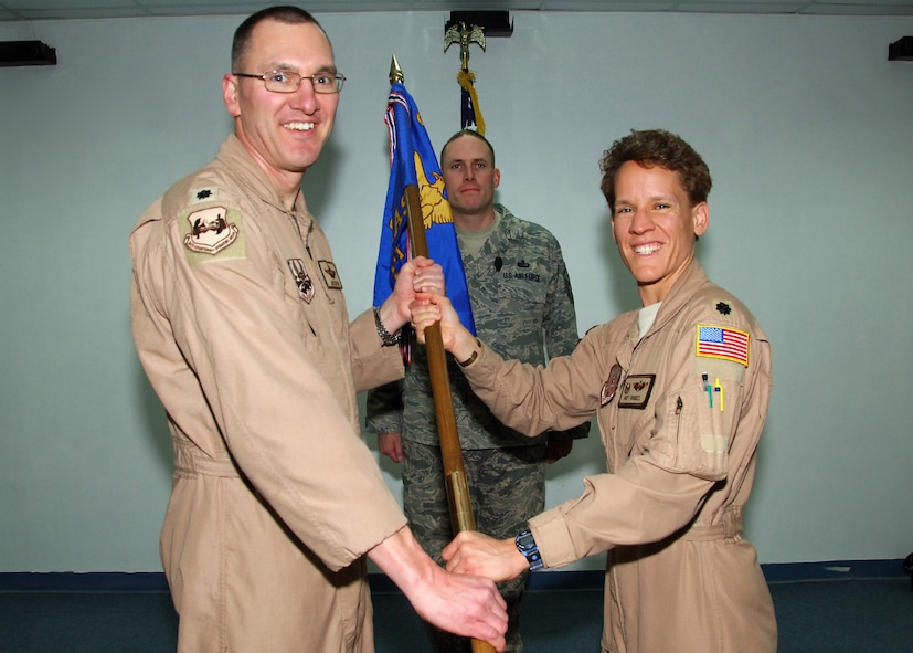 SOUTHWEST ASIA -- Lt.Col. Joe Sexton, 386th Expeditionary Operations Group deputy commander, gives command of the 737th Expeditionary Airlift Squadron to Lt. Col. Buff Burkel at an air base is Southwest Asia, Feb. 18. Colonel Burkel is deployed from the 317th Airlift Group at Dyess Air Force BaseTexas. (U.S. Air Force photo/Senior Airman Courtney Richardson)