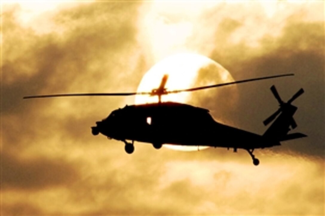 An MH-60S Sea Hawk embarked aboard the aircraft carrier USS John C. Stennis flies plane guard during sunset flight operations in the Pacific Ocean, Feb. 15, 2009.