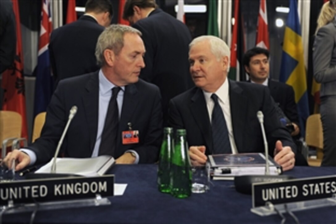 U.S. Defense Secretary Robert M. Gates, right, and British Defence Secretary John Hutton talk at the non-NATO International Security Assistance Force meeting in Krakow, Poland, Feb. 19, 2009.