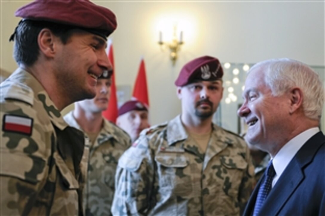 Defense Secretary Robert M. Gates, right, speaks with Polish special forces soldiers recently returned from Afghanistan at the II Mech Corps Headquarters in Krakow, Poland, Feb. 19, 2009. Gates was in Poland to attend to Krakow Defense Ministry Conference.