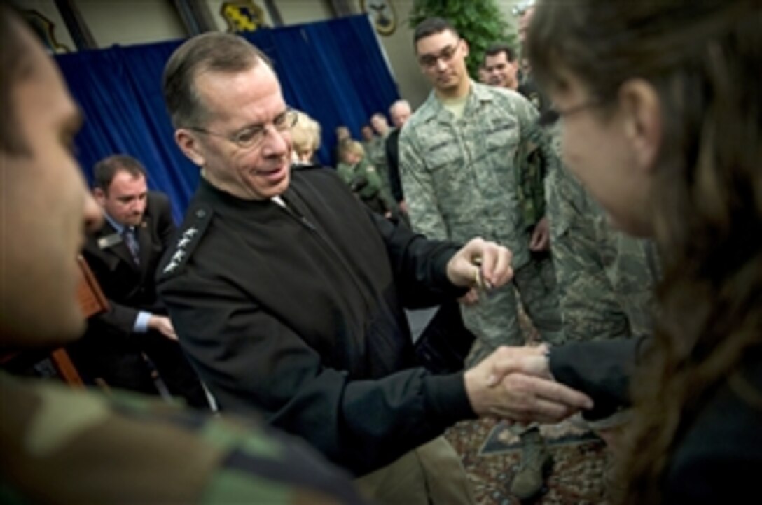 U.S. Navy Adm. Mike Mullen, chairman of the Joint Chiefs of Staff, hands out commemorative coins at the conclusion of an all-hands call on Scott Air Force Base, Ill., Feb. 19, 2009. Mullen is on a two-day trip visiting airmen on Minot and Scott Air Force bases and soldiers on Fort Campbell, Ky. 