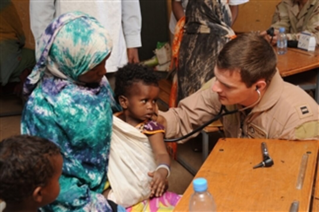 U.S. Navy Lt. Rob Worthing examines a child during a medical civil action program in the village of Aydora, Ethiopia, on Feb. 4, 2009.  Military personnel are providing medical assistance and services to villagers who receive little or no help from elsewhere.  