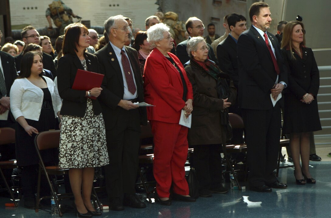 The family of Lance Cpl. Jordan Haerter stands during the Navy Cross ceremony at the National Museum of the Marine Corps Feb. 20. Haerter was killed in action while defending his post in Ramadi, Iraq, April 22, 2008, against a suicide bomber. To date 27 Navy Crosses have been awarded in the Long War.
