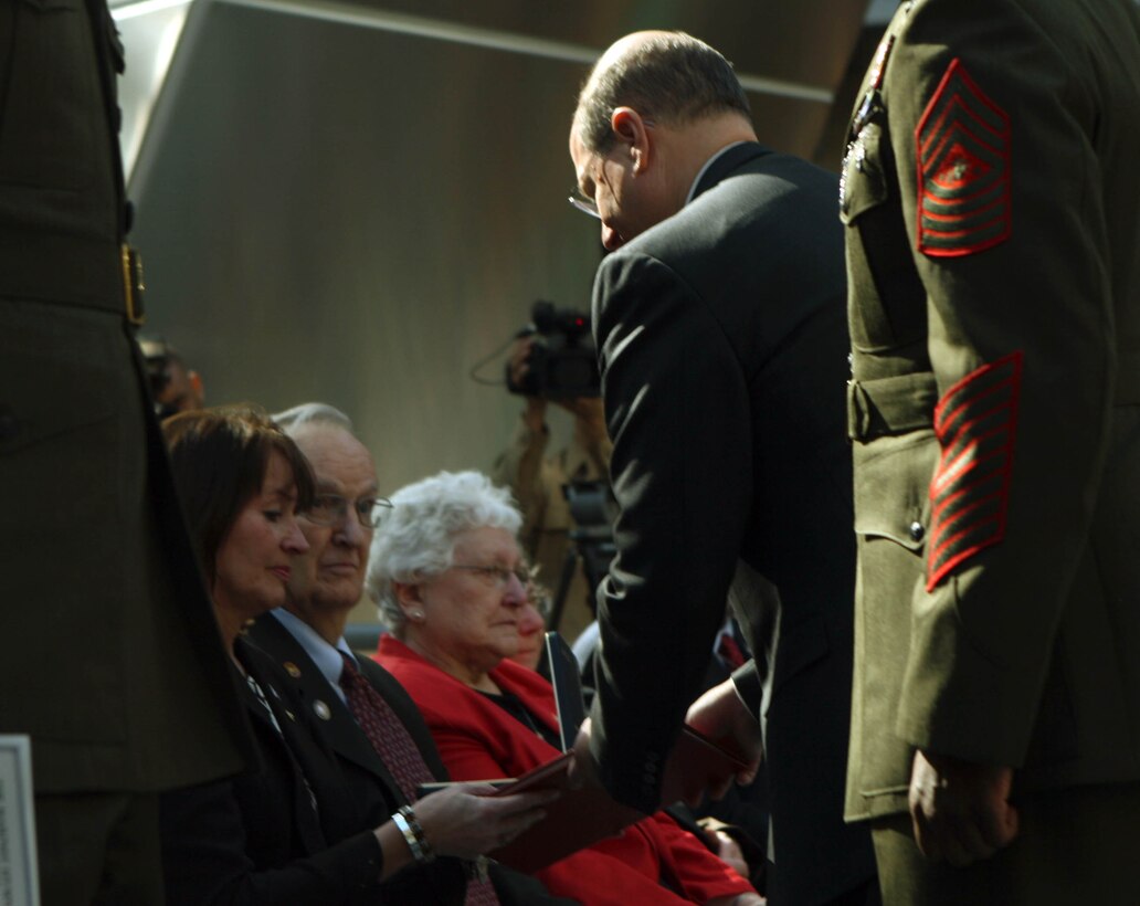 JoAnn Lyles (left) accepts the Navy Cross Medal from Secretary of the Navy Donald Winter (right) on behalf of Lance Cpl. Jordan Haerter, during a Navy Cross ceremony at the Museum of the Marine Corps, Feb. 20. “Jonathan and Jordan were shining examples of the finest of America’s next generation,” Winter said. “When faced with danger they had no time to go to their chain of command and no time to assess the situation, they were forced to rely on their discipline and their training.”