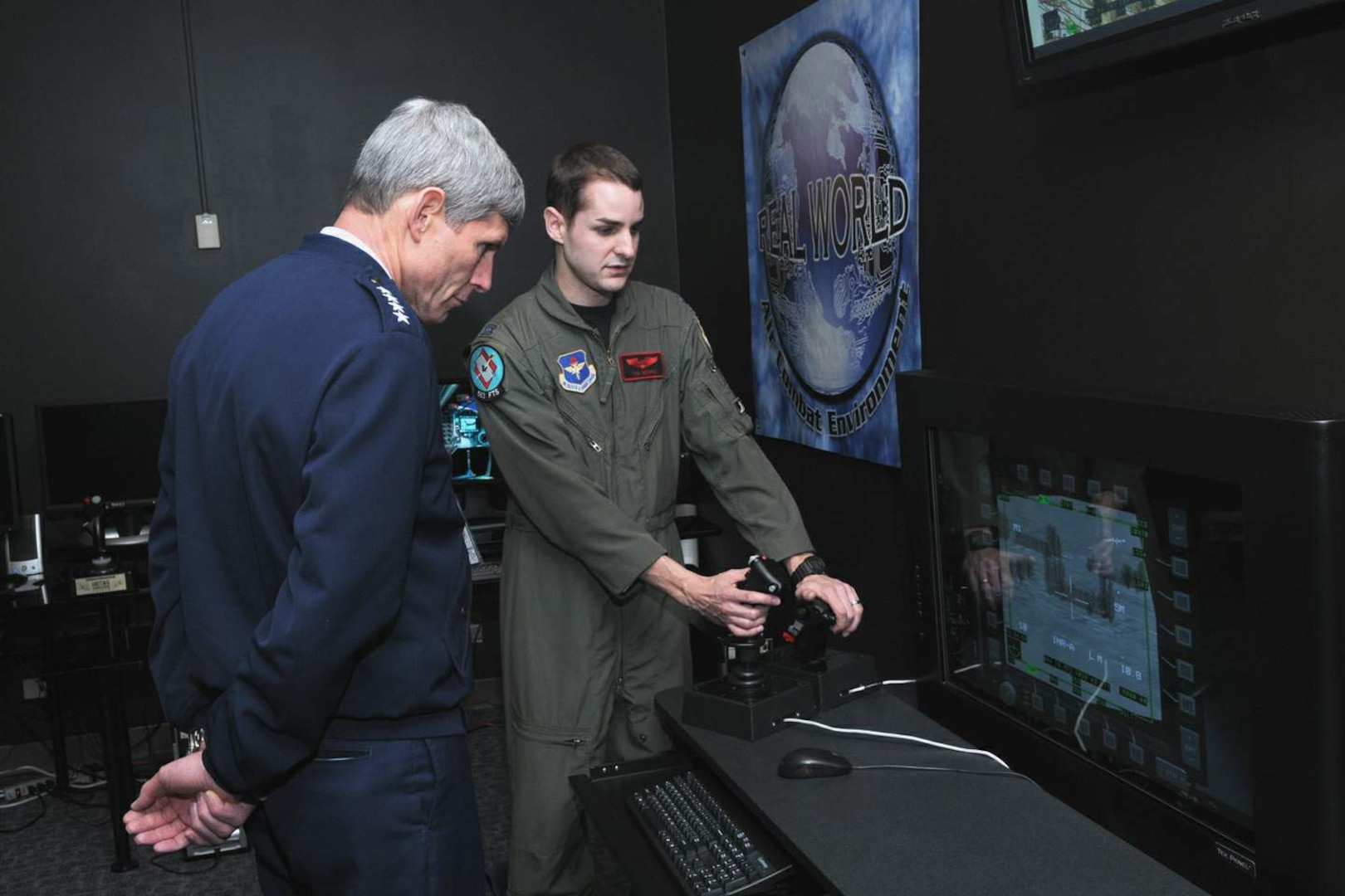 Air Force Chief of Staff Gen. Norton Schwartz observes as Capt. Tom Moore, a Unmanned Aircraft System Fundamentals Course flight commander, demonstrates a training position in the Simulation Development Laboratory Feb. 19 during the general's visit to the 563rd Flying Training Squadron at Randolph Air Force Base, Texas. (U.S. Air Force photo/Joel Martinez)