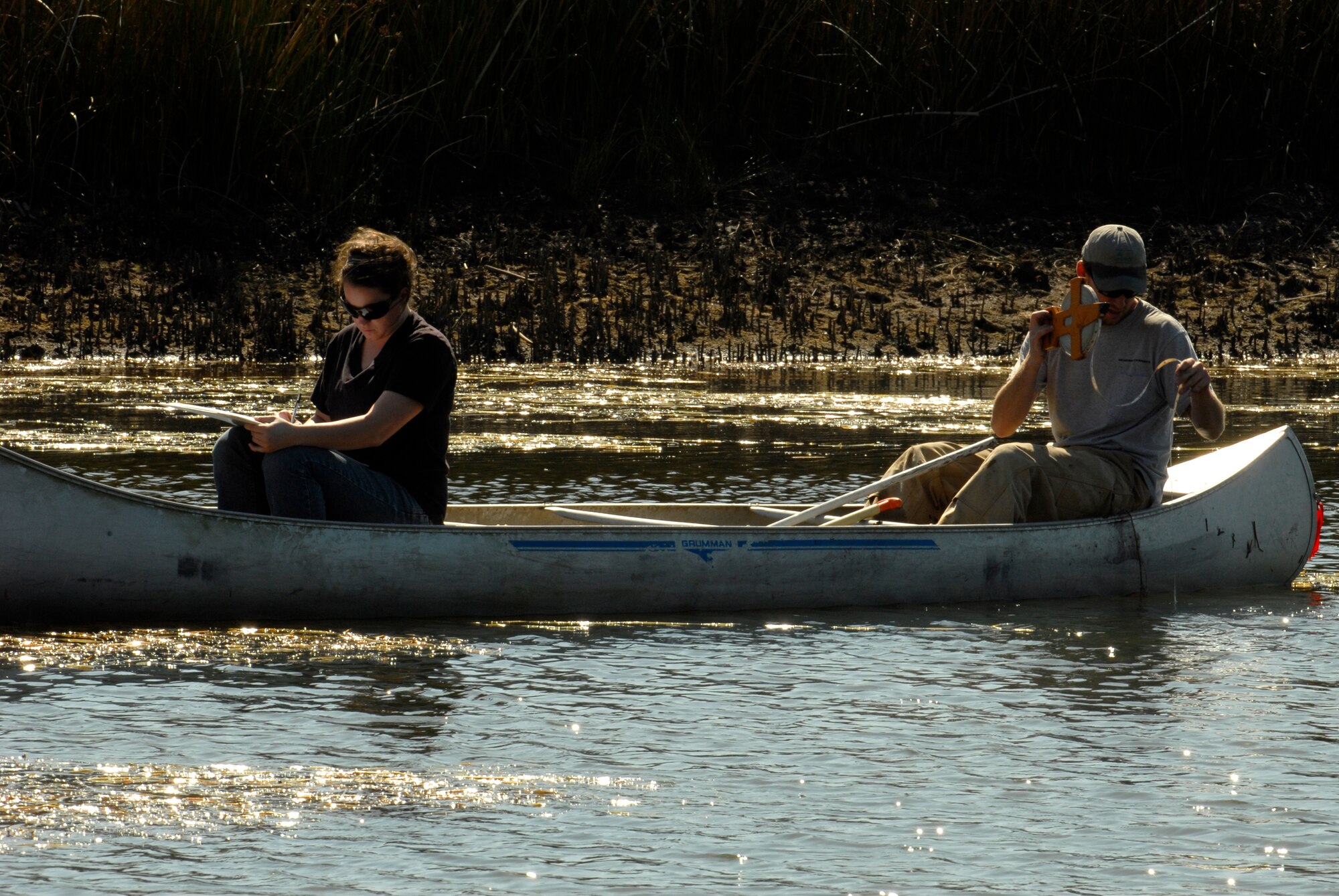 VANDENBERG AIR FORCE BASE, Calif. --  Shane James and Jasmine Kidwell, environmental scientists with the 30th Civil Engineer environmental flight, check the depth of a pond to collect pollen samples from the bottom. (U.S. Air Force photo/Senior Airman Christian Thomas)


