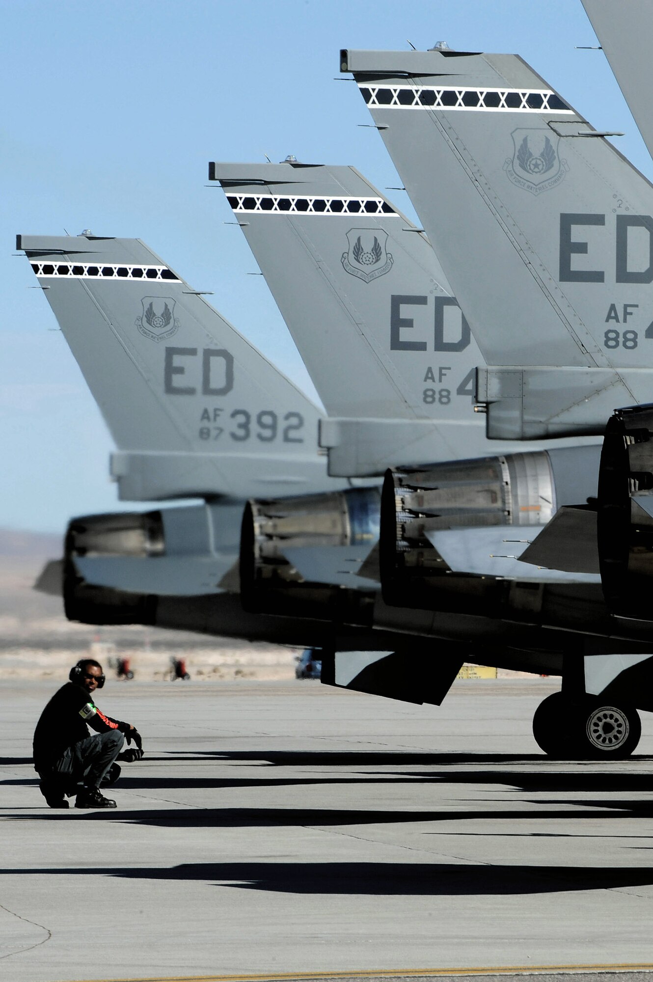 Robert Macadoo performs preflight inspections on F-16 Fighting Falcons in support of Red Flag 09-2 Feb 4 at Nellis Air Force Base, Nev. Red Flag is a multi-national exercise providing a realistic environment to practice combat scenarios. The experience gained during the exercise is vital to the survival of air crews in combat. Mr. Macadoo is a weapons specialist with the 416th Flight Test Squadron at Edwards Air Force Base, Calif. (U.S. Air Force photo/Senior Airman Nadine Y. Barclay)