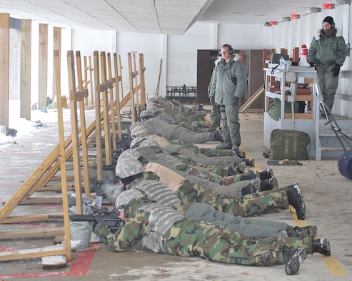 Members of the 114th Security Forces Squadron bundled up to qualify on the M-16 during annual training at Volk Field, Wis. Jan. 9th. Tech. Sgts. Gretchen Hansen and Jeremy Wajer oversee the activities.
