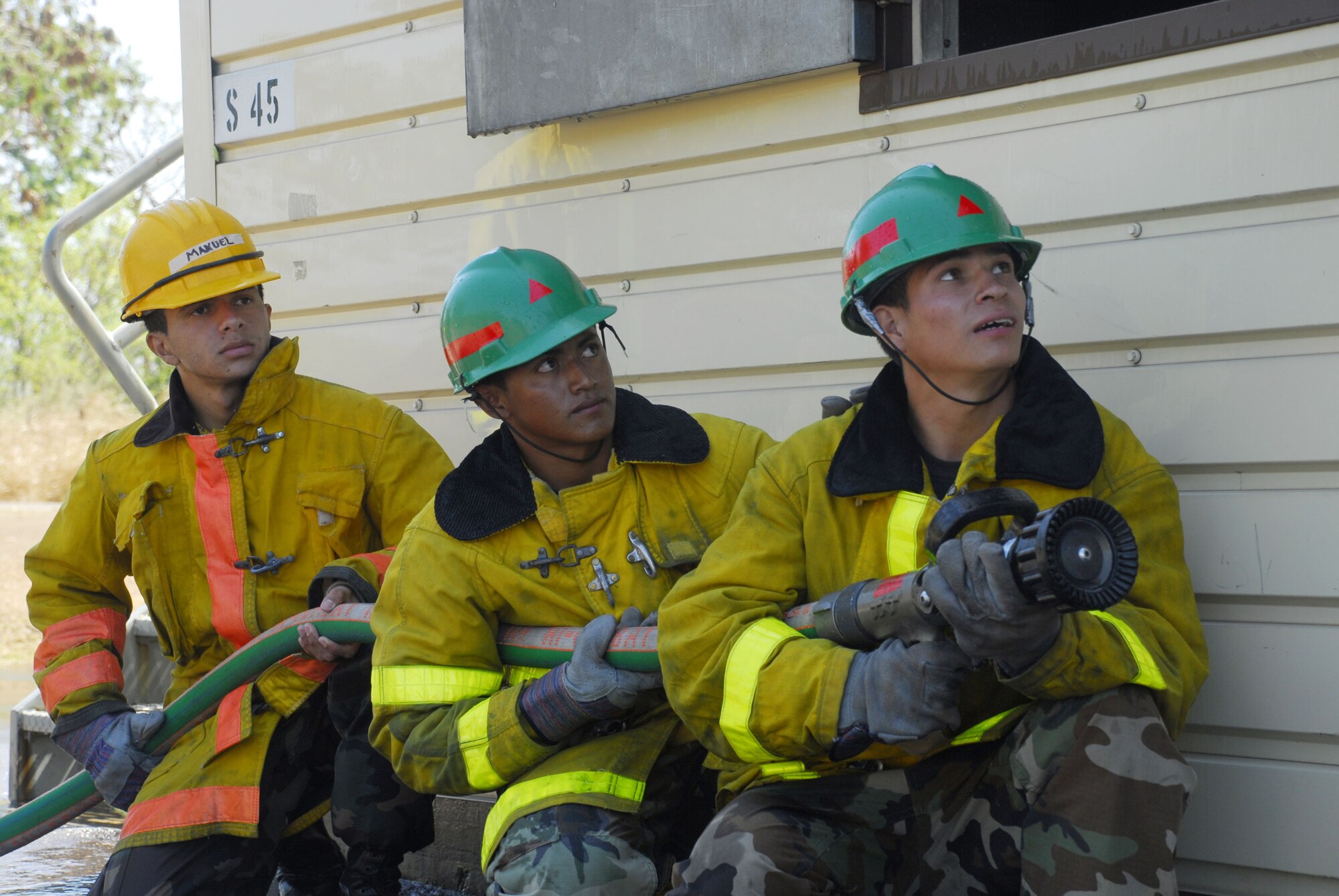 SOTO CANO AIR BASE, Honduras - Honduran Airmen conduct structural fire training at the JTF-B burn house here Feb. 19.  Members of the joint task force conducted a subject matter expert exchange with Honduran airmen here covering wildland firefighting, land navigation and structural firefighting.  (U.S. Air Force photo/Tech. Sgt. Rebecca Danét)