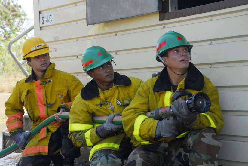 SOTO CANO AIR BASE, Honduras - Honduran Airmen conduct structural fire training at the JTF-B burn house here Feb. 19.  Members of the joint task force conducted a subject matter expert exchange with Honduran airmen here covering wildland firefighting, land navigation and structural firefighting.  (U.S. Air Force photo/Tech. Sgt. Rebecca Danét)