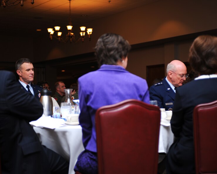 DYESS AIR FORCE BASE, Texas - Major General Cecil Richardson, Air Force Chief of Chaplains, and Colonel Robert Gass, 7th Bomb Wing commander, follow along as Dyess Airman read prayers and scripture from different religious faiths during the National Prayer Breakfast here, Feb. 18.  The National Prayer Breakfast is an annual event that was started by members of the Senate and House prayer groups and President Eisenhower in 1953.  (U.S. Air Force photo by Staff Sgt. Alan Garrison) 
