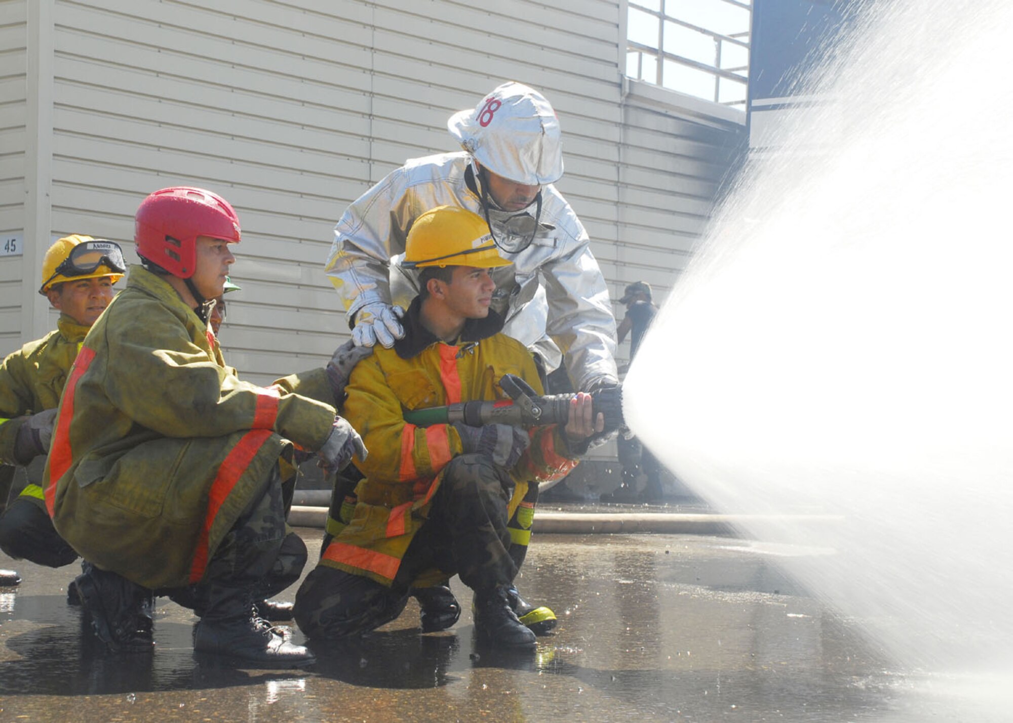 SOTO CANO AIR BASE, Honduras - Mr. Herberth Gaekel, Joint Task Force-Bravo Fire Department chief of fire prevention, shows Honduran airmen how to employ a fire hose for fire supression.  Members of JTF-B conducted a subject matter expert exchange with Honduran airmen here Feb. 16-19 covering several aspects of fire fighting.  (U.S. Air Force photo/Tech. Sgt. Rebecca Danét)