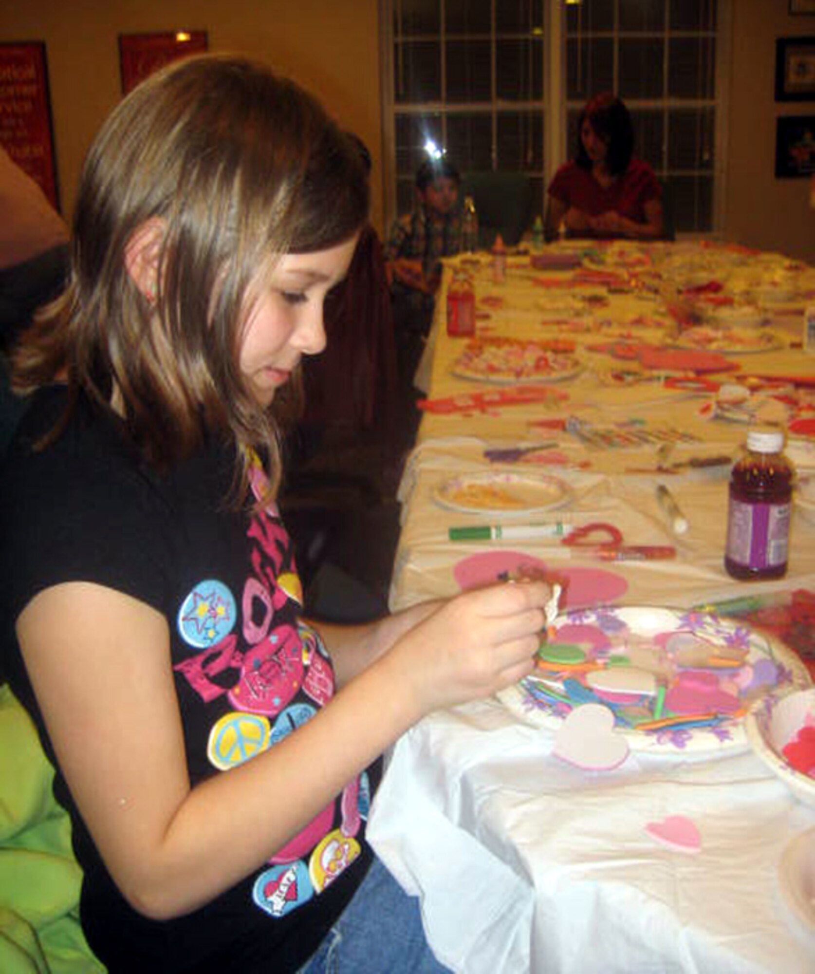 Victoria Bathe, 10, daughter of Master Sgt. Tom Bathe, participates in United Communities’ Valentine’s Day Craft Night recently. UC frequently holds events for its residents, including the recent Bingo Night and holiday craft nights. The next events, the St. Patrick’s Day coloring contest and guess how many contest, will begin March 2. (Courtesy photo)