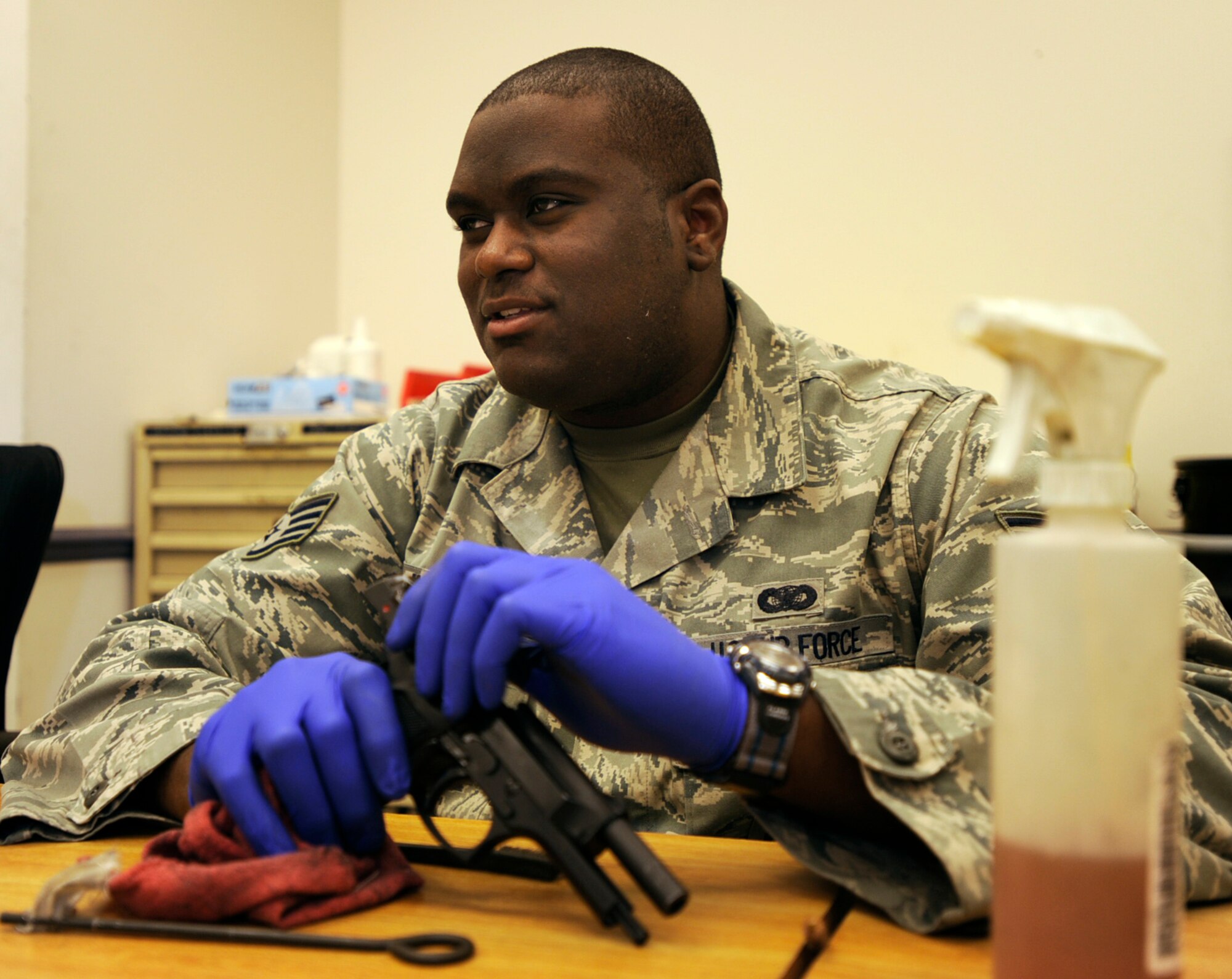 Staff Sgt. Jamel Warren cleans a 9mm pistol while on duty with the 931st Air Refueling Group at McConnell Air Force Base, Kan. Sergeant Warren is a Reservist assigned to the 931st's Security Forces as a combat arms instructor. (U.S. Air Force photo/Tech. Sgt. Jason Schaap)