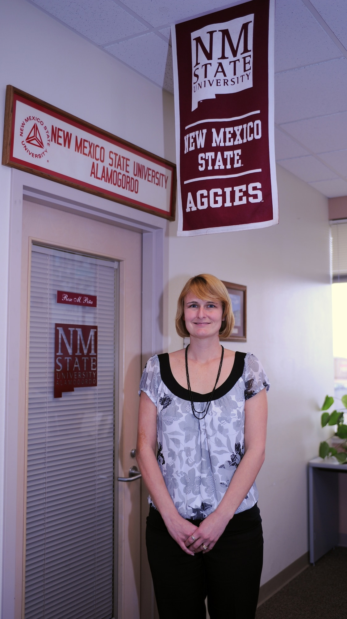 Ms. Michelle Swingle, wife of Master Sgt. Steven Swingle, 49th Civil Engineer Squadron, poses outside of the New Mexico State University Alamogordo office at Holloman Air Force Base, N.M., Feb. 10. Ms. Hunter is currently enrolled in the Office Skills Certification program, a collaborate effort between NMSU-A and the Air Force Aid Society, which provides Air Force spouses with a certification worth $1,000. (U.S. Air Force photo/Airman 1st Class Sondra M. Escutia)