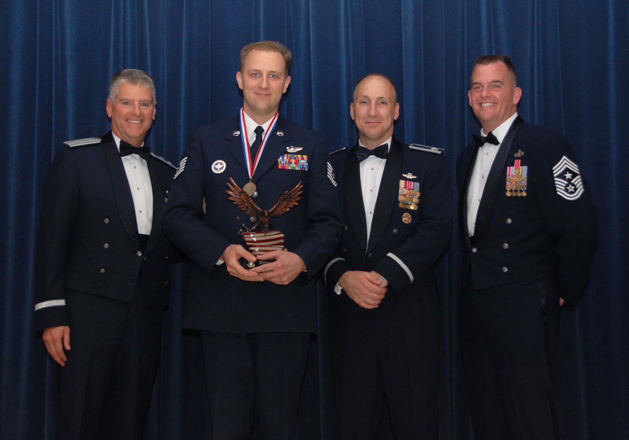 ALTUS AIR FORCE BASE, Okla. -- Tech. Sgt. Scott Mills received the 97th Air Mobility Wing’s Volunteer of the Year Award at the Annual Awards banquet Feb.13. The award was presented by Maj. Gen. Anthony Przybyslawski, Air Education and Training Command Vice Commander, 97th Air Mobility Wing Commander Col. David Allvin and Chief Master Sgt. Eric Malloy, 97th Air Mobility Wing Command Chief Master Sergeant.(U.S. Air Force photo/Airman 1st Class Cherice I. Bryant)
