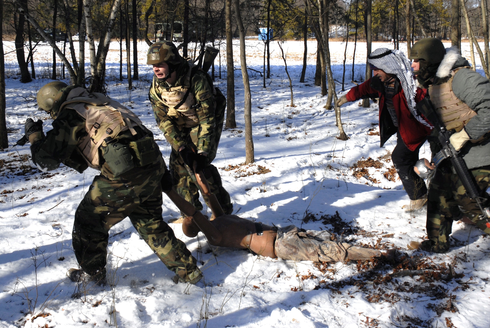 Students in the Advanced Contingency Skills Training Course 09-3 participate in a scenario for combat first aid on Feb. 5, 2009, on a Fort Dix, N.J., range.  The course, taught by the U.S. Air Force Expeditionary Center's 421st Combat Training Squadron, prepares Airmen for upcoming deployment providing combat skills training in everything from combat first aid and convoy operations to patrolling and tactics.  (U.S. Air Force Photo/Staff Sgt. Paul R. Evans)