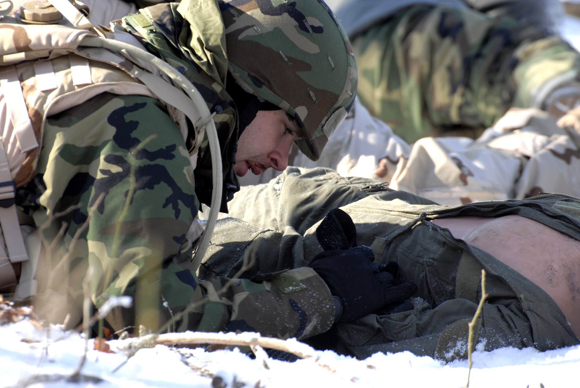 A student in the Advanced Contingency Skills Training Course 09-3 participates in a scenario for combat first aid on Feb. 5, 2009, on a Fort Dix, N.J., range.  The course, taught by the U.S. Air Force Expeditionary Center's 421st Combat Training Squadron, prepares Airmen for upcoming deployment providing combat skills training in everything from combat first aid and convoy operations to patrolling and tactics.  (U.S. Air Force Photo/Staff Sgt. Paul R. Evans)