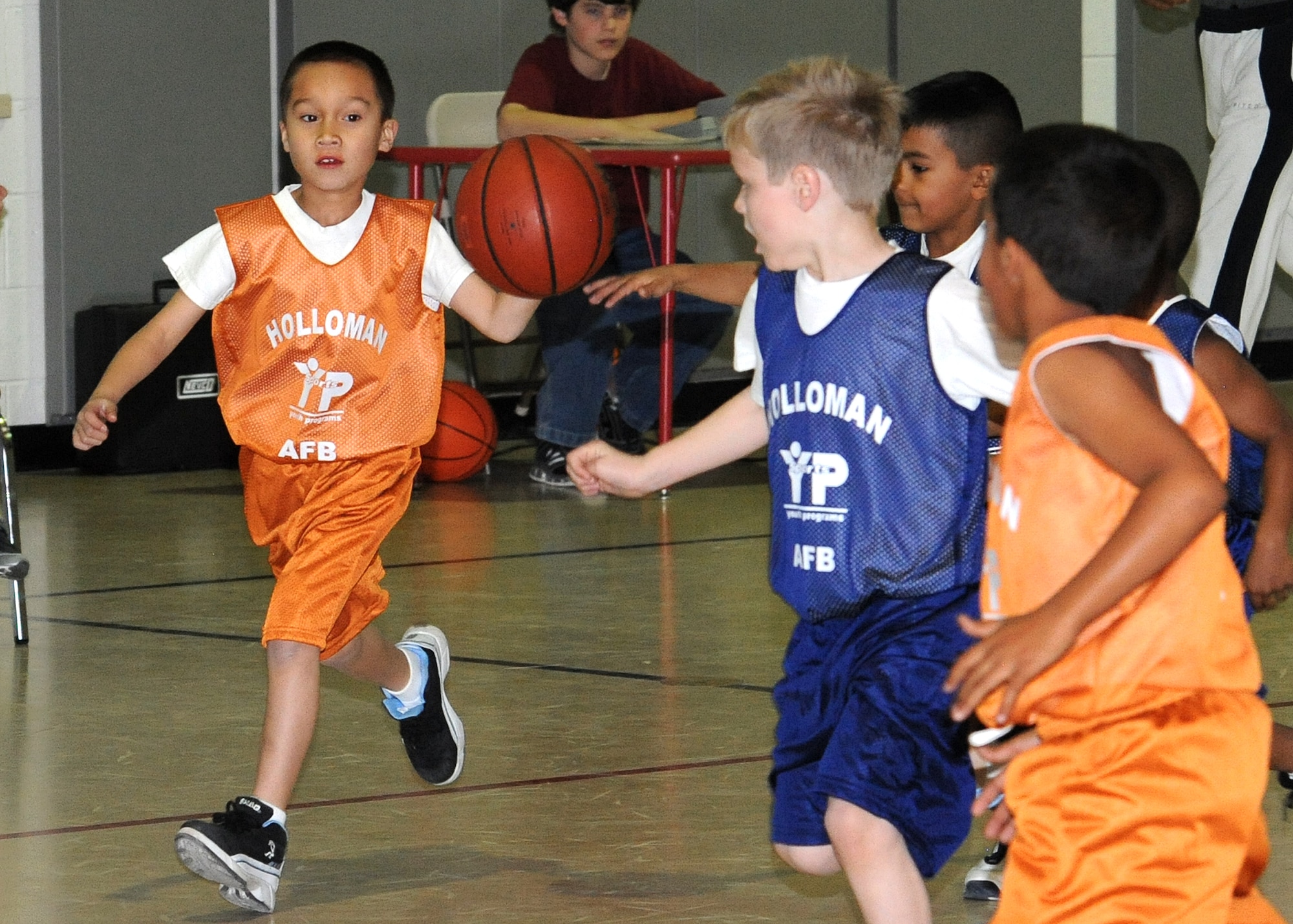 Children from the Youth and Teens Center play in a basketball game at Holloman Air Force Base, N.M., Feb. 12.  The Holloman Youth and Teen Center host several seasonal sports programs for youths such as soccer, tee ball, baseball and basketball. (U.S. Air Force photo/Senior Airman Michael Means)

