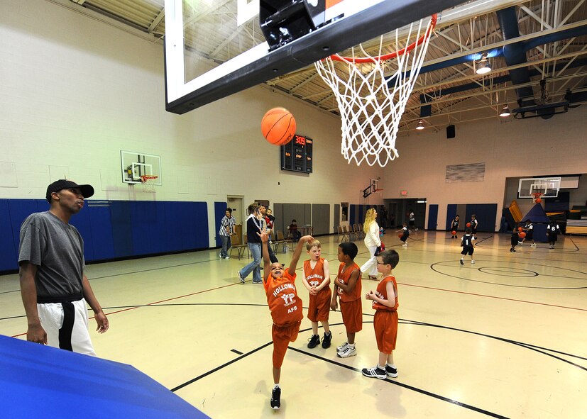 Staff Sgt. Mark Daniels, 4th Space Control Squadron, coaches children at the Youth and Teens Center before a basketball game at Holloman Air Force Base, N.M., Feb. 12. The Holloman Youth and Teen Center host several seasonal sports programs for youths such as soccer, tee ball, baseball and basketball. (U.S. Air Force photo/Senior Airman Michael Means)