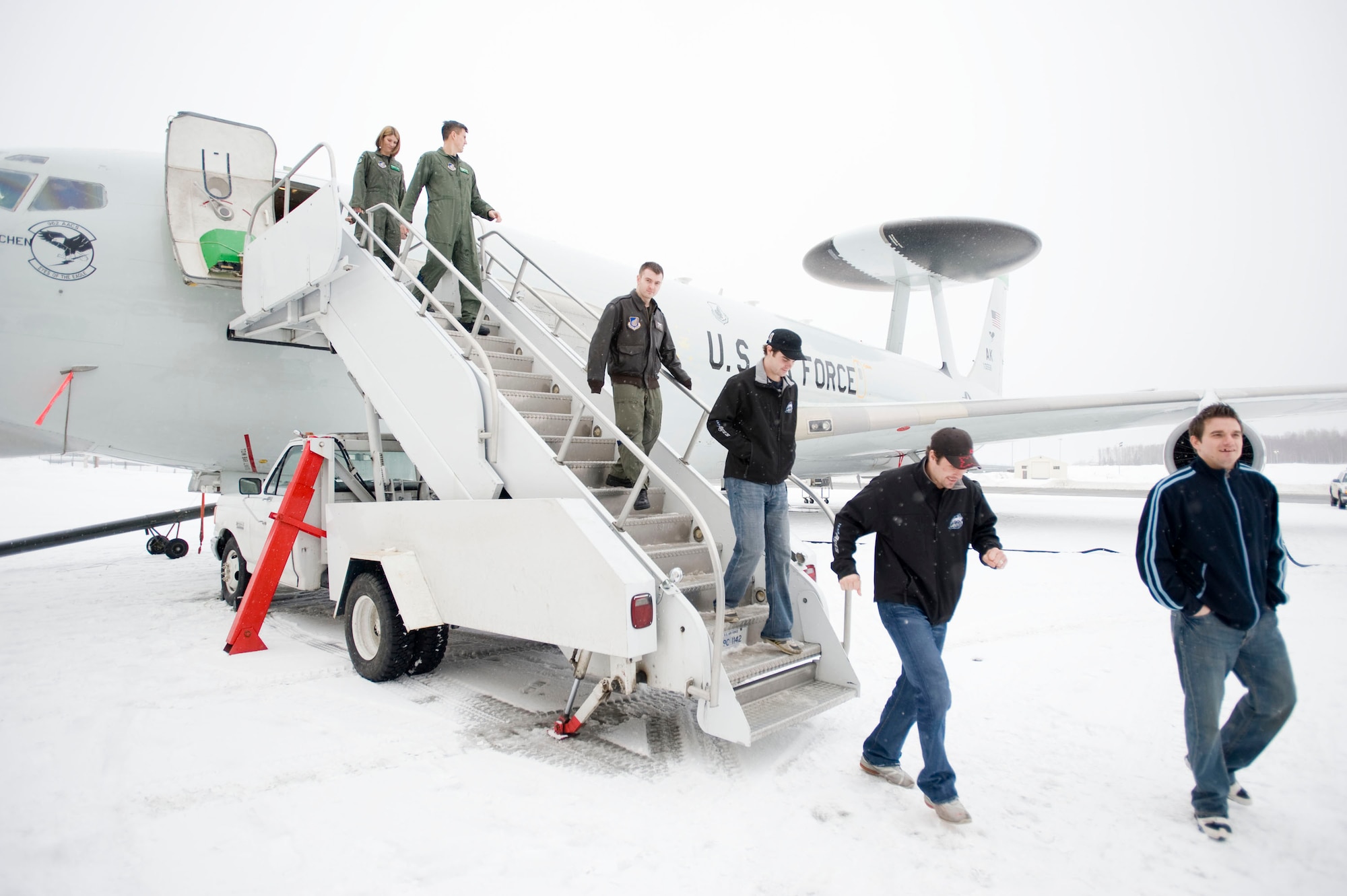ELMENDORF AIR FORCE BASE, Alaska -- Alaska Aces hockey players exit off the E-3 Sentry AWACS after taking a tour with 962nd Airborne Air Control Squadron members Feb. 19, 2009. Officials from the 962nd AACS invited the Aces players to tour the 962nd AACS facility, the AWACS hangar and an E-3 Sentry before the friendly competition. Both Canadian and U.S. Air Force members of the 962nd made up squadron team. (U.S. Air Force photo/Senior Airman Jonathan Steffen)
