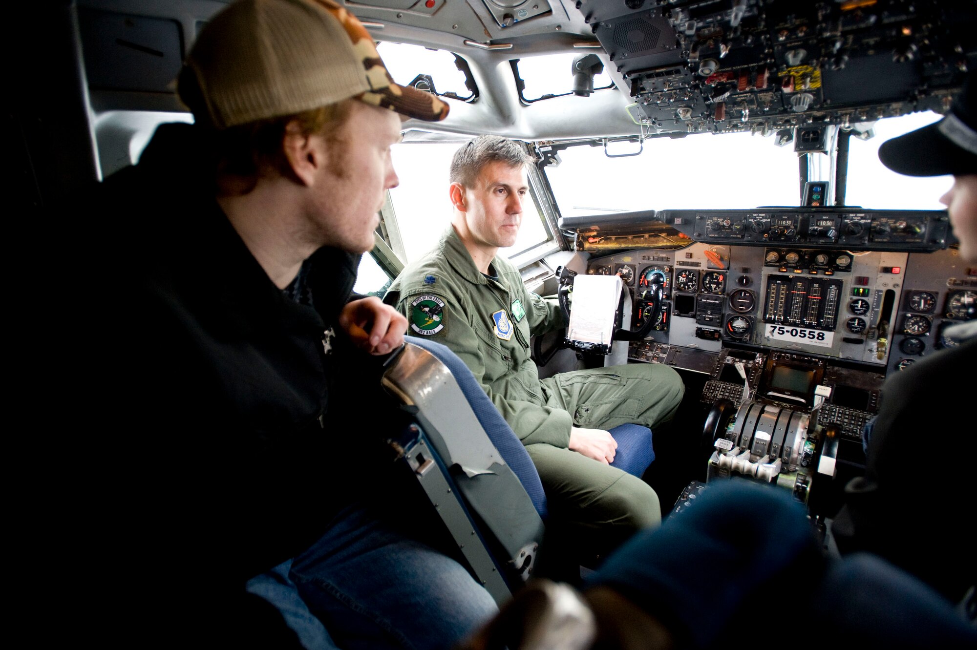 ELMENDORF AIR FORCE BASE, Alaska -- Lt. Col. Michael Mote, 962nd Airborne Air Control Squadron, provides a tour of an E-3 Sentry AWACS cockpit to Alaska Aces hockey players Ryan Turek and Alexandre Imbeault Feb. 19, 2009. Officials from the 962nd AACS invited the Aces players to tour the 962nd AACS facility, the AWACS hangar and an E-3 Sentry before the friendly competition. Both Canadian and U.S. Air Force members of the 962nd made up squadron team. (U.S. Air Force photo/Senior Airman Jonathan Steffen)