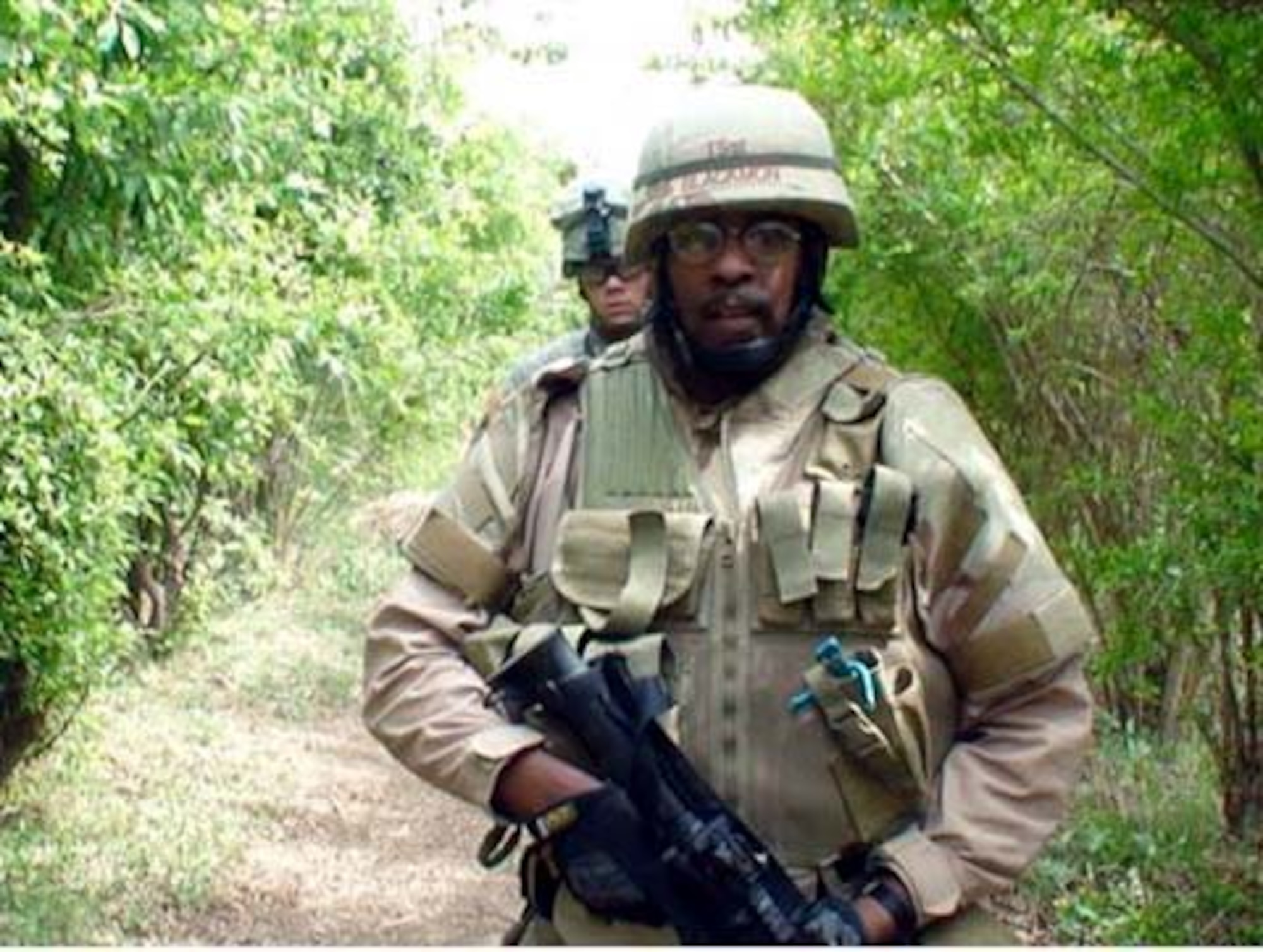 Then Tech. Sgt. Anthony Blackmon, 28th Civil Engineer Squadron explosive ordnance disposal flight chief, escorts his team toward a suspected weapons cache while deployed at Sather Air Base, Iraq, April 1, 2007.  Sergeant Blackmon was awarded a Bronze Star for this deployment because of his quick and decisive actions during an attack by Al Qaeda forces May 12, 2007. (U.S. Air Force/courtesy photo)